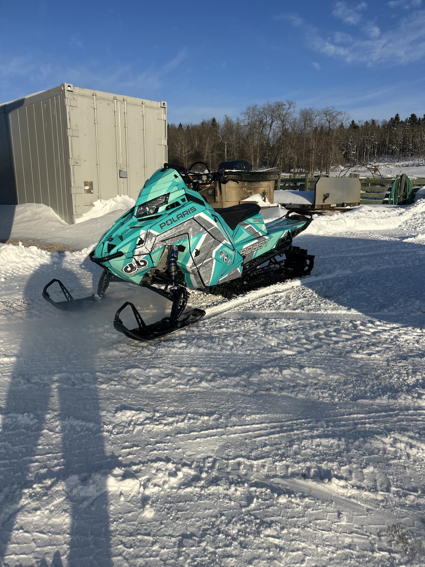 A Polaris Matryx Mountain snowmobile with gray, white, jade, and tiffany blue Ponsor Equalizer custom vinyl wrap.