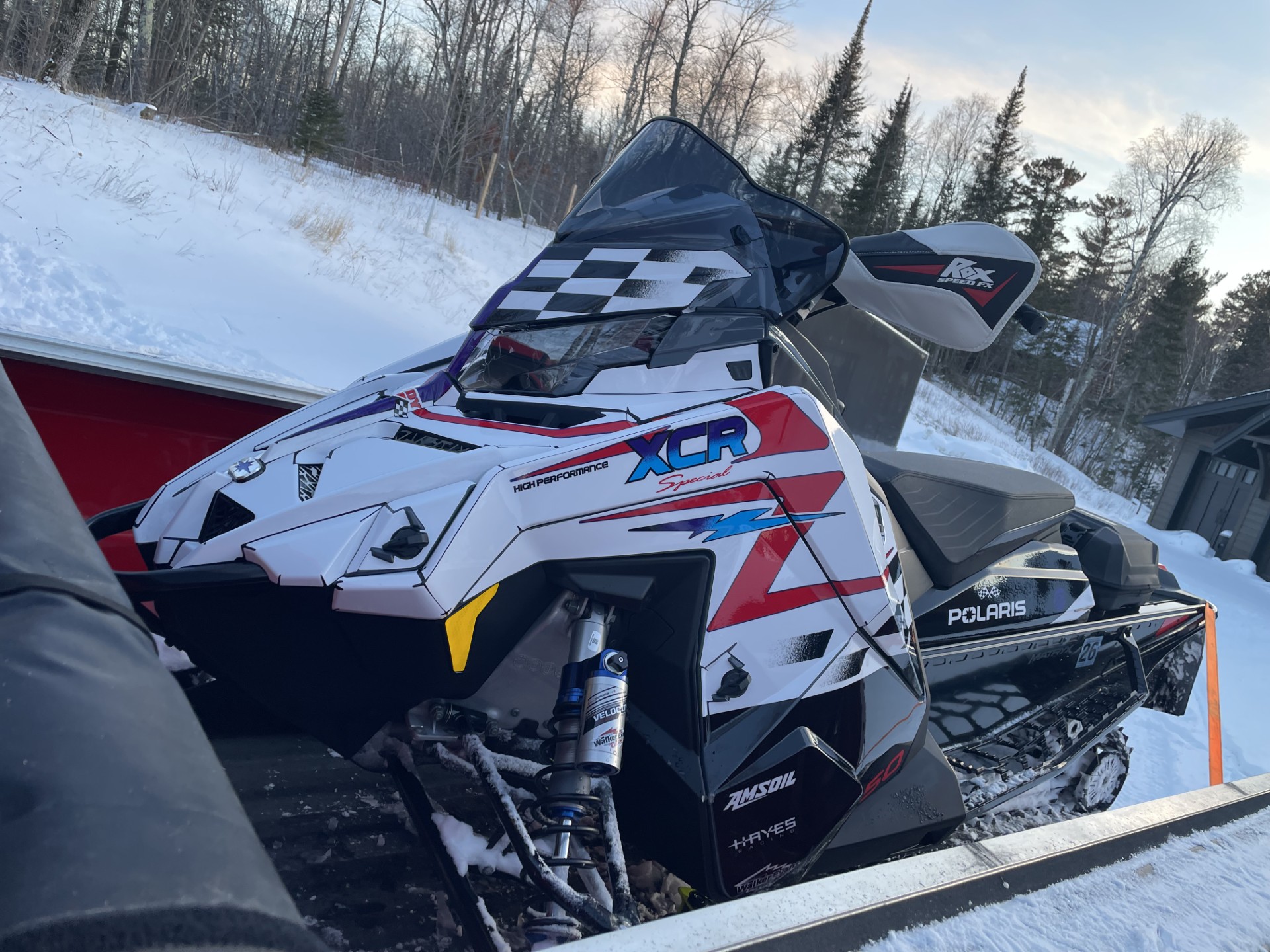 A Polaris Matryx Trail snowmobile with a black, white, Polaris red, Yamaha blue, khaos purple, and octane blue Retro 96 XCR custom vinyl wrap.