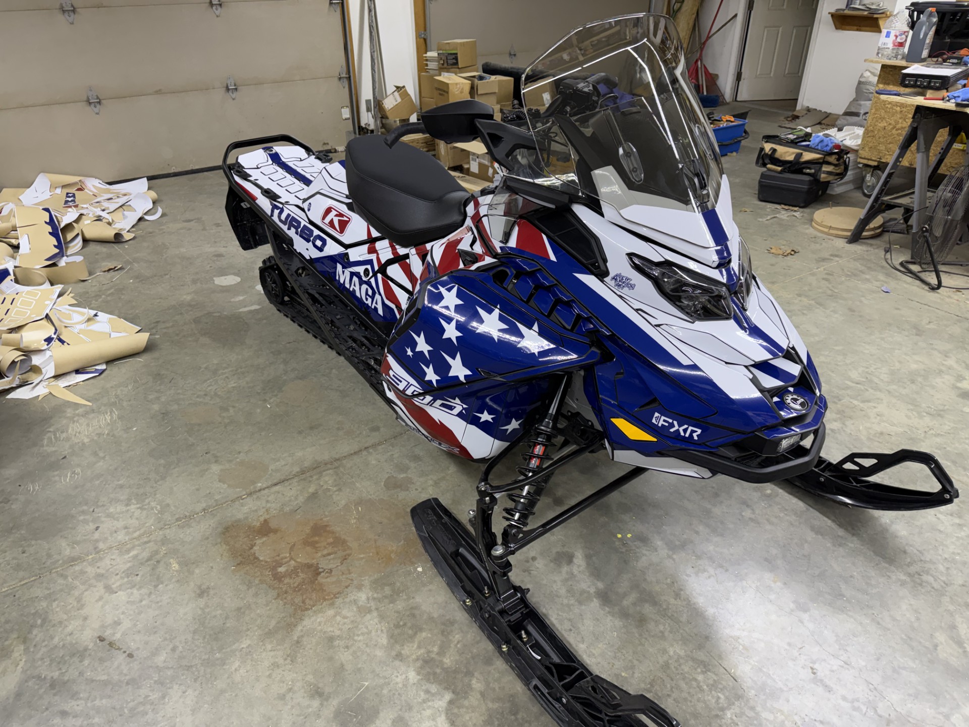 A SkiDoo Gen5 Trail snowmobile with a ink blue, white, and sunset red Leif Alvarsson Merica custom vinyl wrap.
