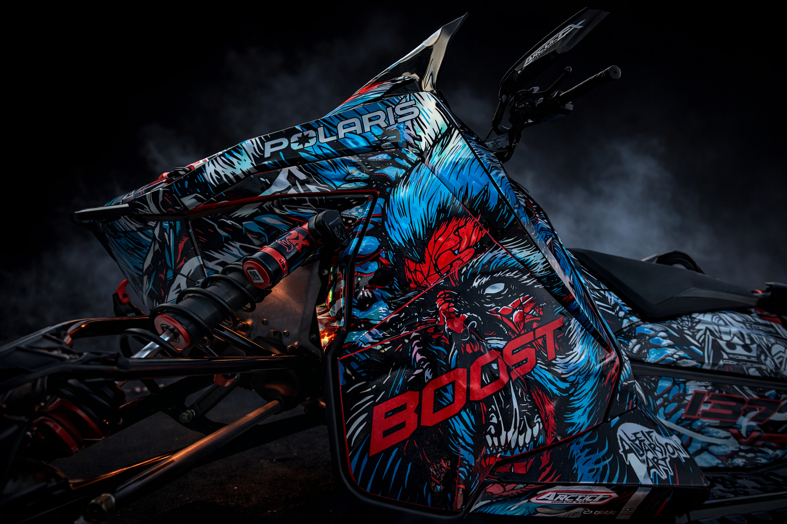 A Polaris Matryx Trail snowmobile with a black, white, octane blue, and race orange Leif Alvarasson Tree Slayer custom vinyl wrap with prismatic chrome vinyl and halo flake laminate.