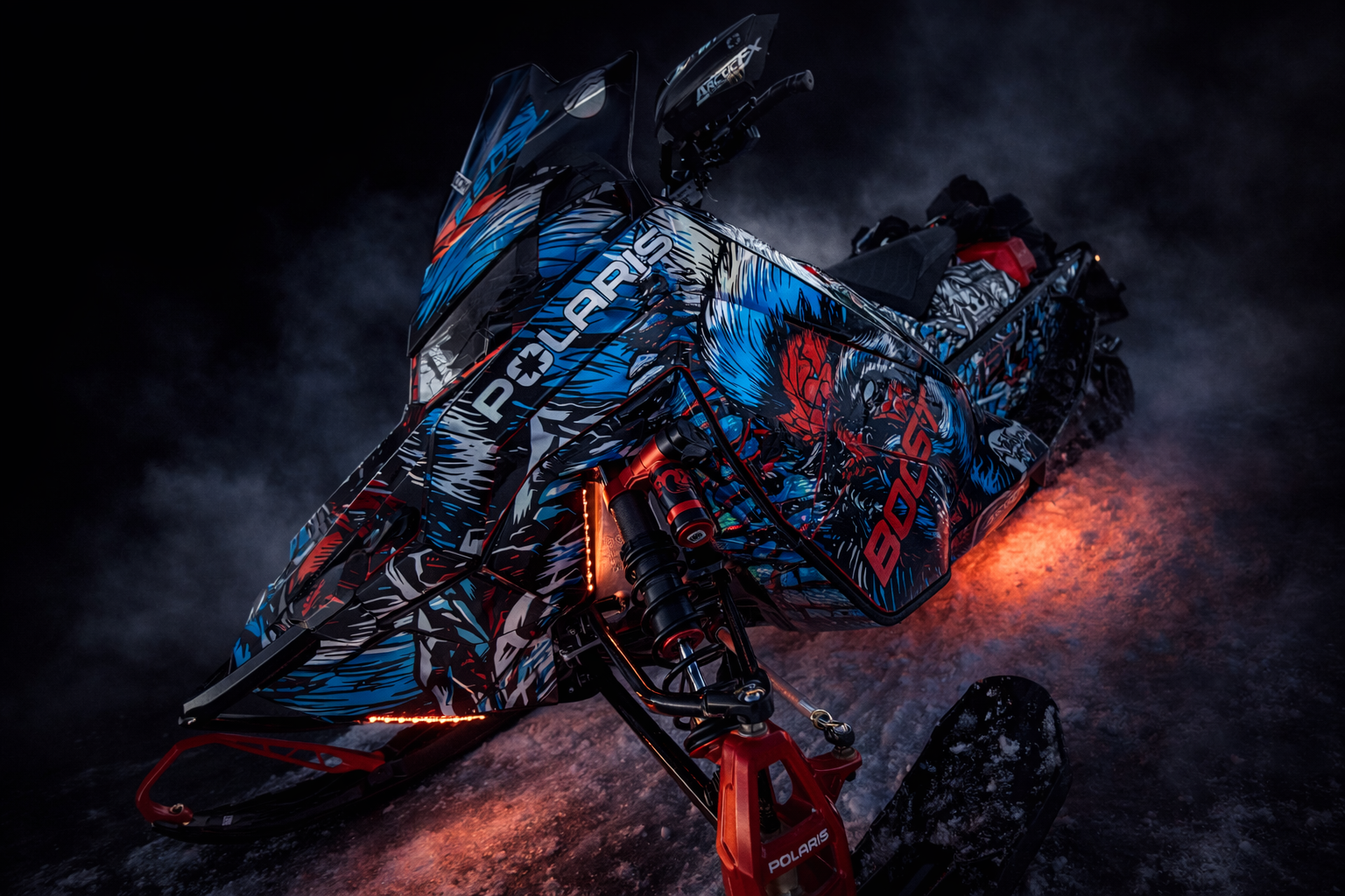 A Polaris Matryx Trail snowmobile with a black, white, octane blue, and race orange Leif Alvarasson Tree Slayer custom vinyl wrap with prismatic chrome vinyl and halo flake laminate.