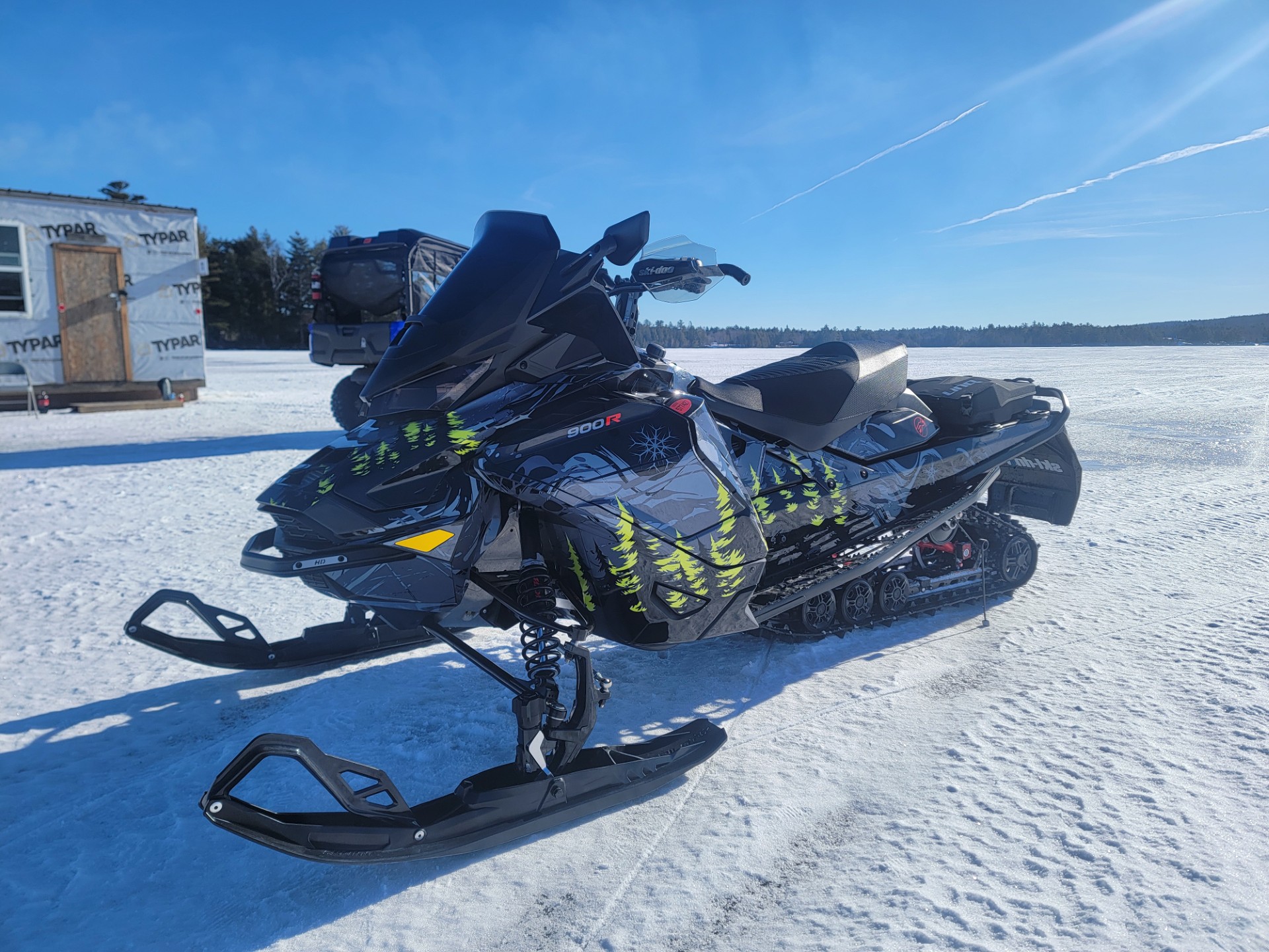 A SkiDoo Gen4 Wide Body snowmobile with a black, monument gray, stealth gray, and manta green Sub Zero custom vinyl wrap.