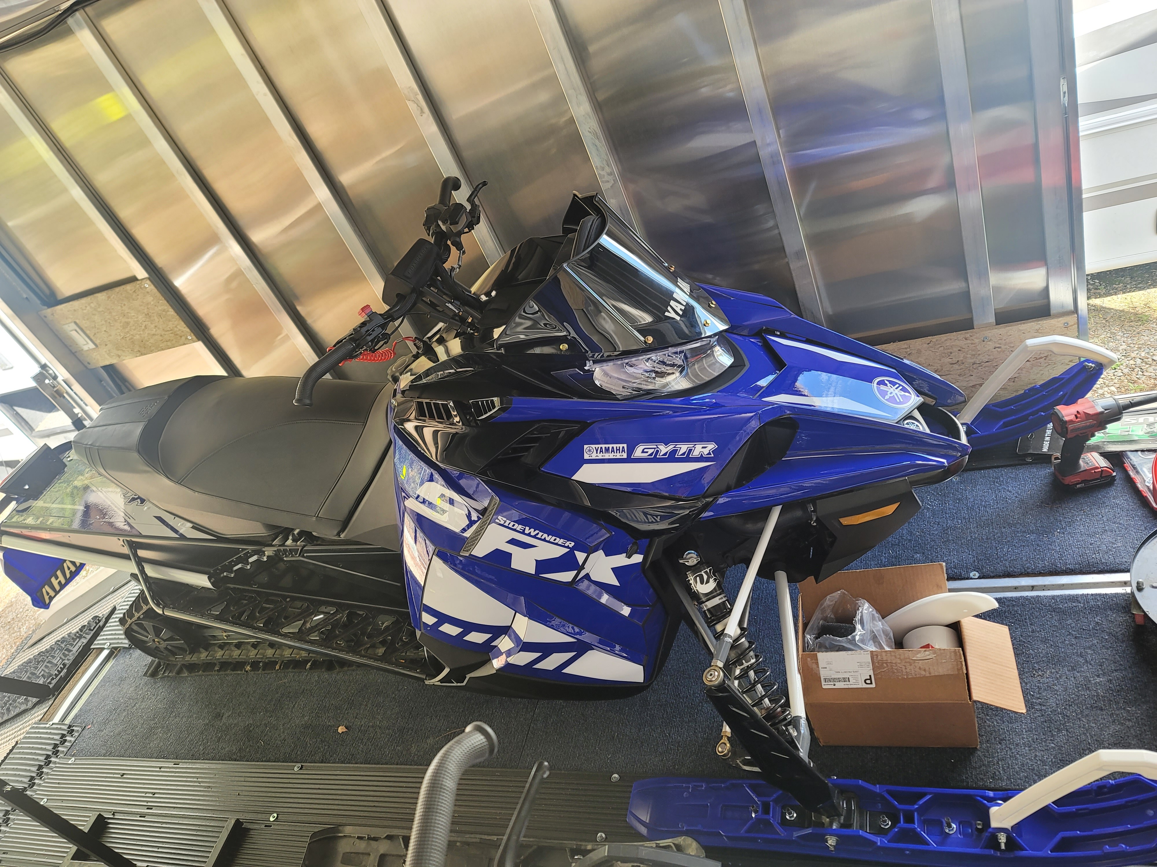 A Yamaha Sidewinder snowmobile with a Yamaha blue custom vinyl wrap