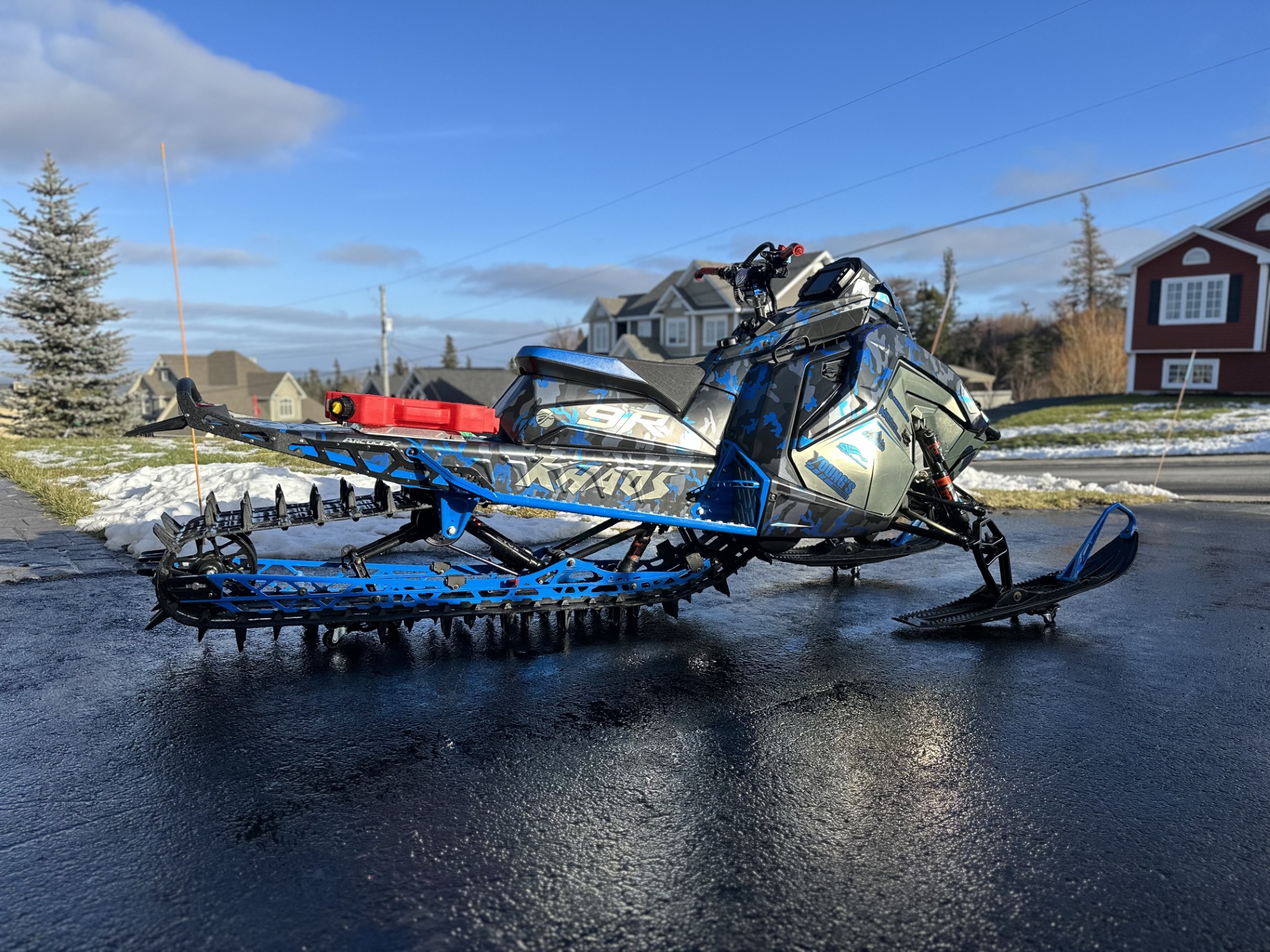 A Polaris Matryx Mountain snowmobile with a custom designed vinyl wrap with chrome vinyl and matte laminate.