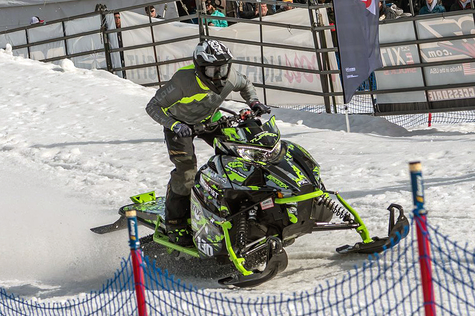 A Arctic Cat Ascender snowmobile with a green, gray, and black grunge RR Camo custom vinyl wrap.