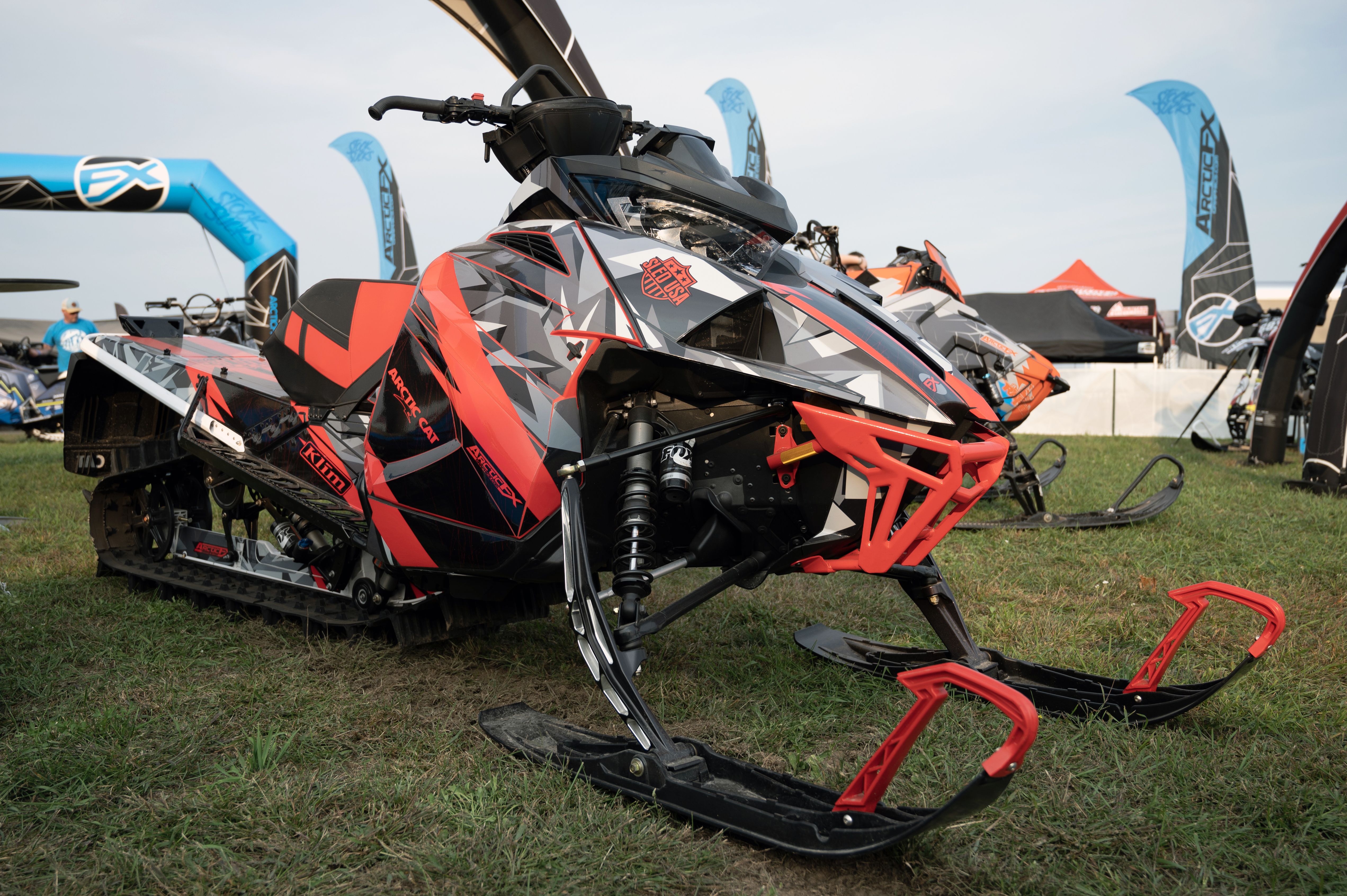 A Arctic Cat Ascender snowmobile with a lime squeeze, black and gray geometric pattern Y2K custom vinyl wrap.