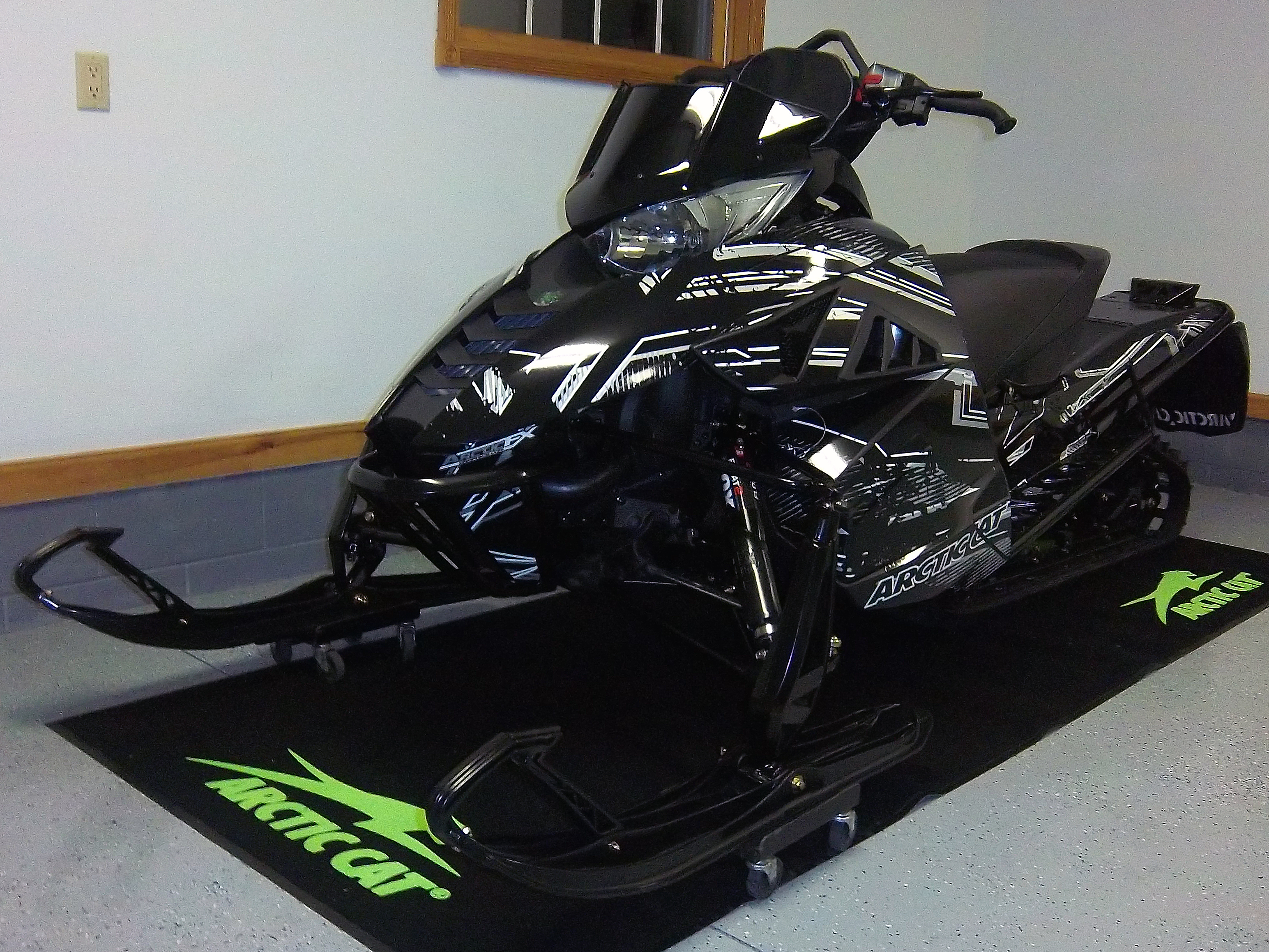 A Arctic Cat Proclimb snowmobile with a gray and black grunge stripes Blackout custom vinyl wrap.
