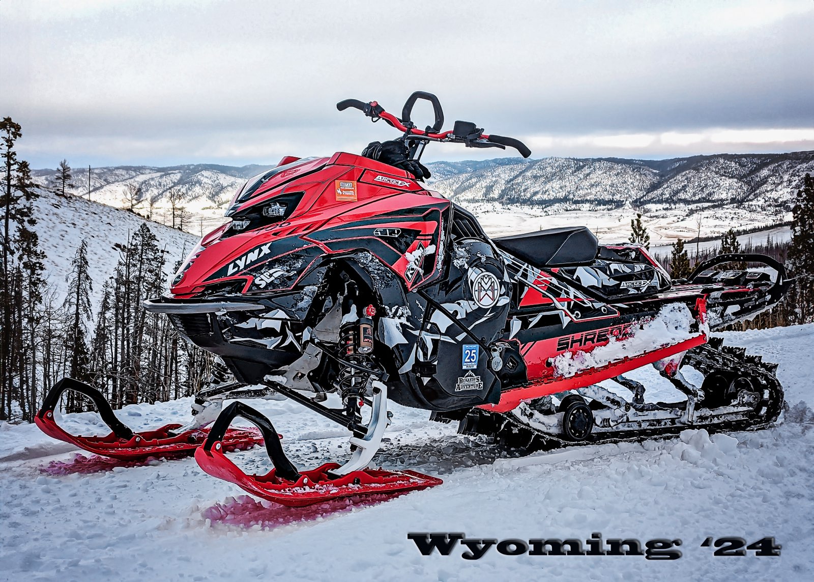 A Lynx snowmobile with a red, white and black Burandt Vista wrap with logos added