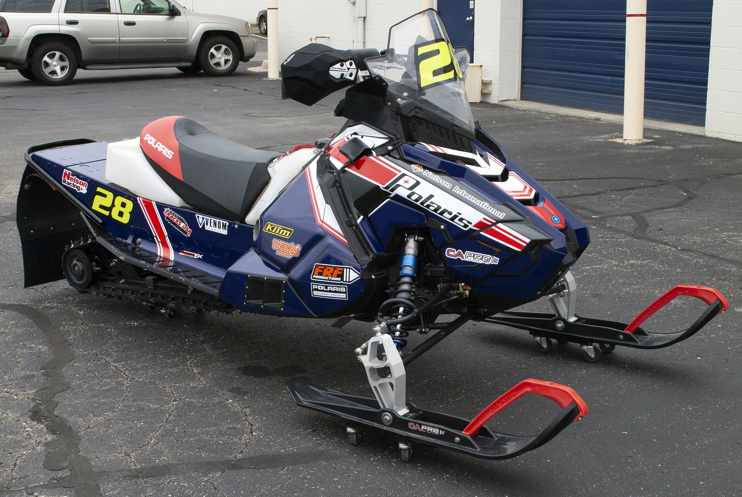 A Polaris Axys 600r snowmobile with a red, white, and blue retro Nelson racing custom vinyl wrap.