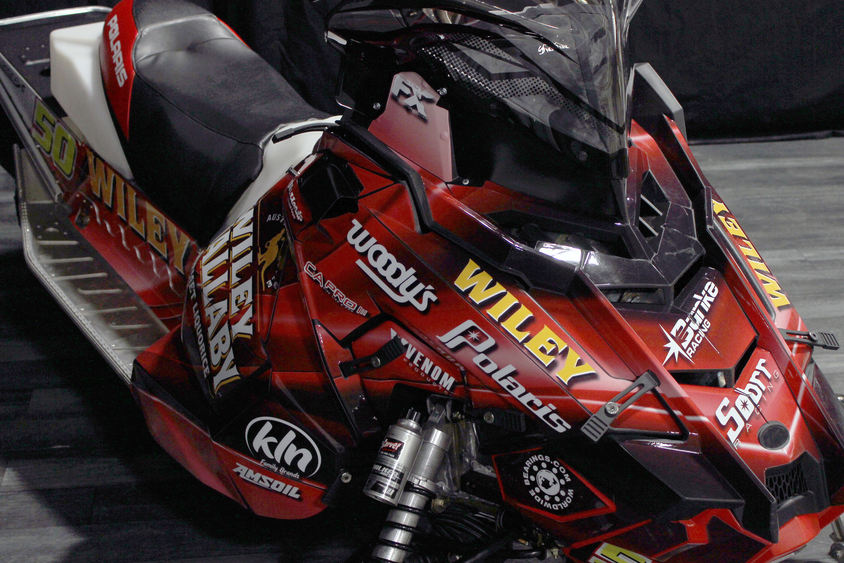 A Polaris Axys 600r snowmobile with a red licorice Wiley Wallaby racing custom vinyl wrap.