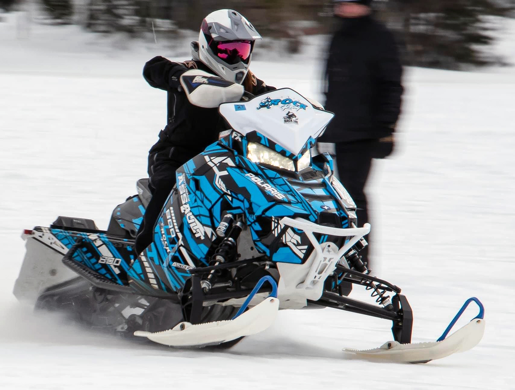 A Polaris Axys Crossover snowmobile with a blue, white, and black Evasion custom vinyl wrap.