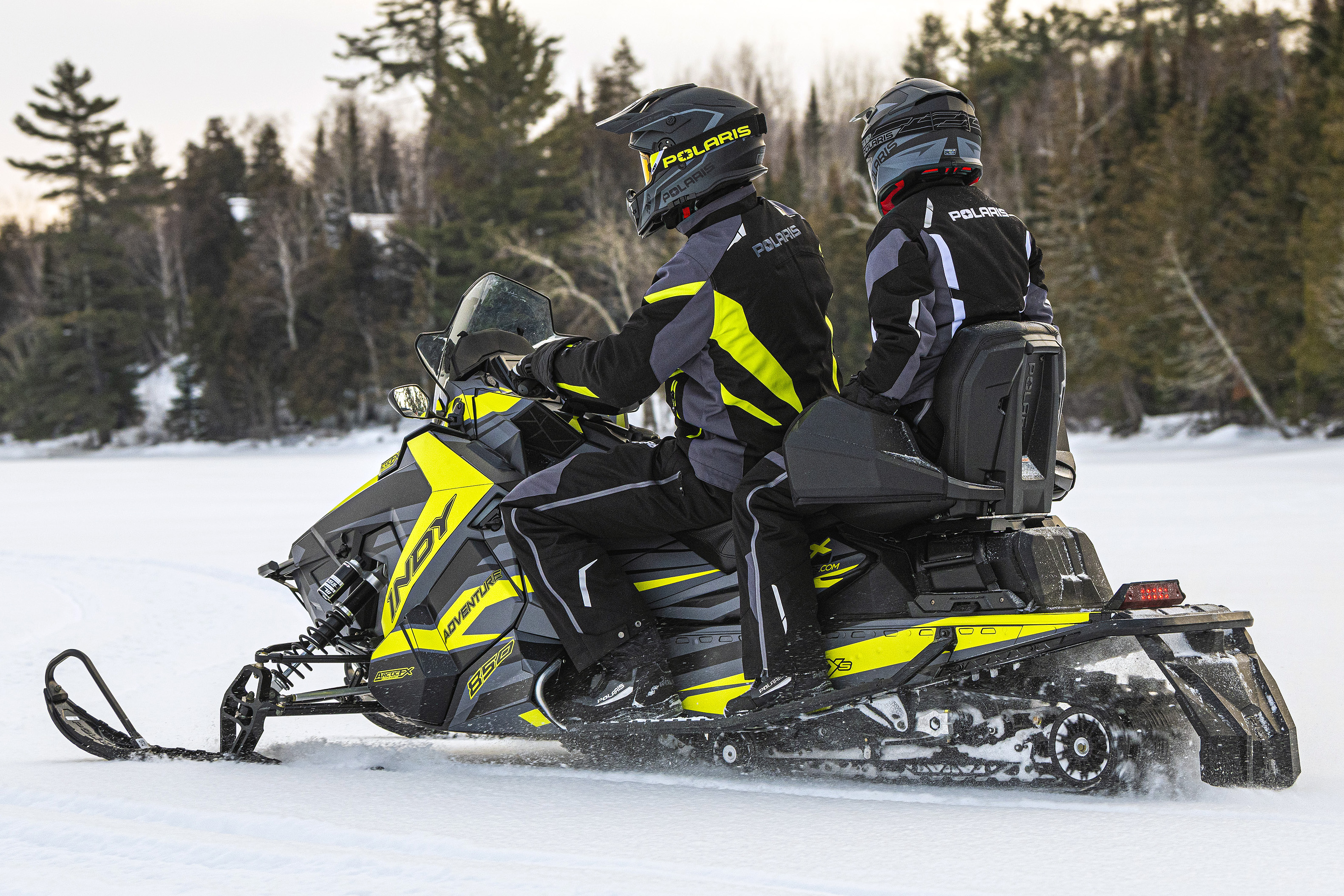 A Polaris Axys Crossover snowmobile with a lime squeeze, gray, and black Relay custom vinyl wrap.