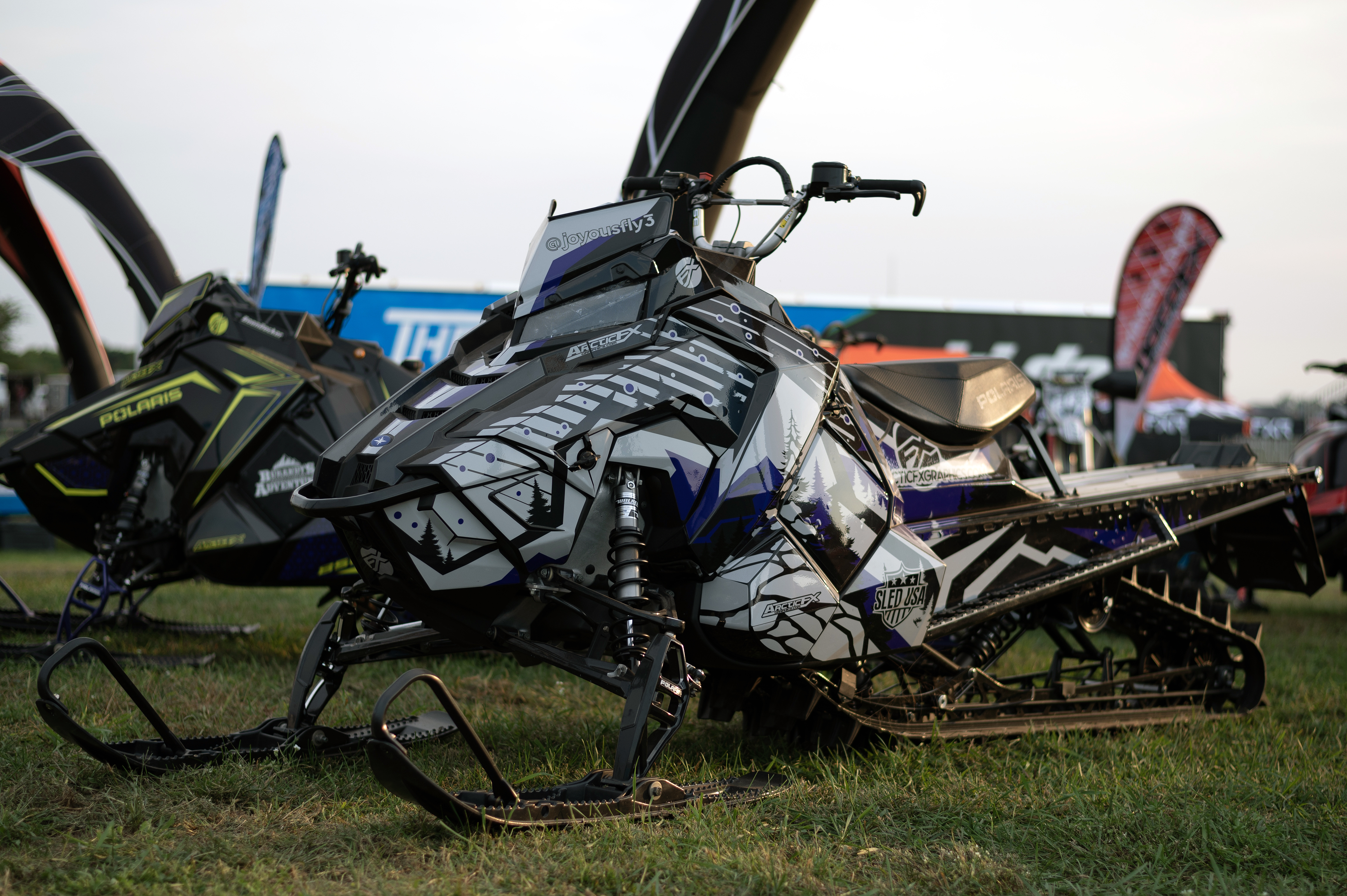 A Polaris Axys Mountain snowmobile with a gray, purple, and black Leif Alvarsson Kingdom custom vinyl wrap.