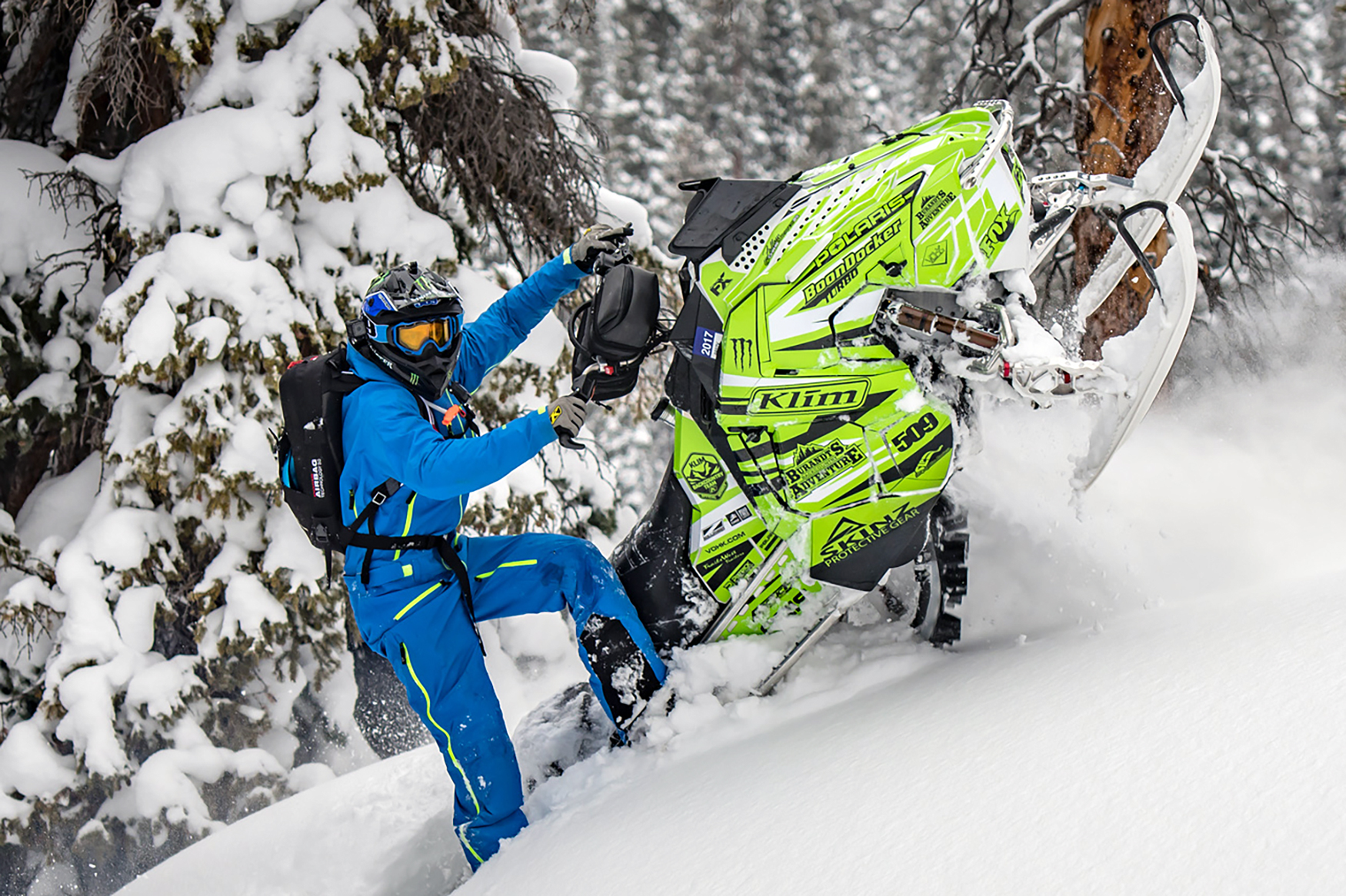 A Polaris Axys Mountain snowmobile with a lime, black, and white stripes Burandt Evolution custom vinyl wrap.