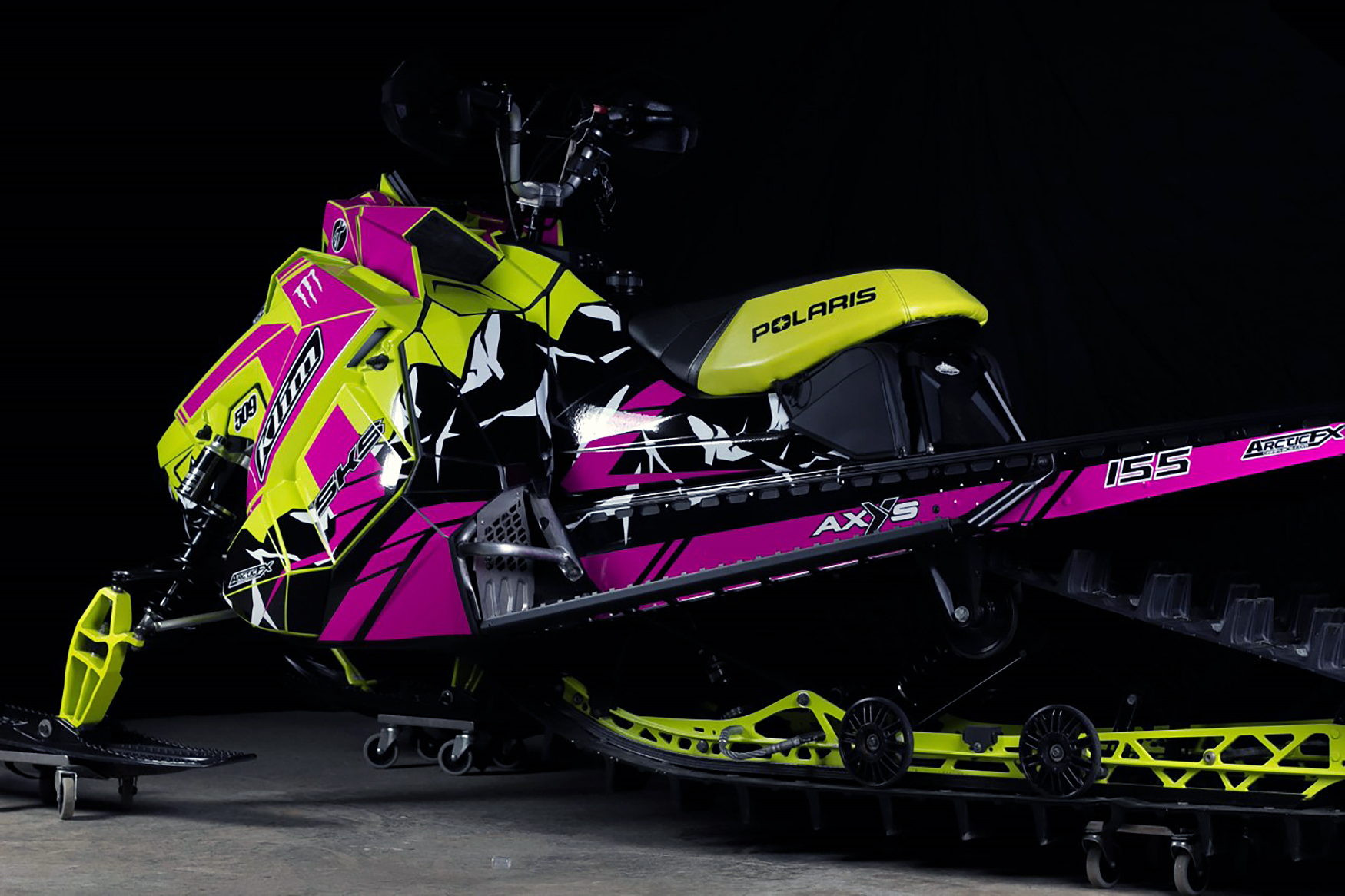 A Polaris Axys Mountain snowmobile with a white, aqua, and black Burandt Vista custom vinyl wrap.