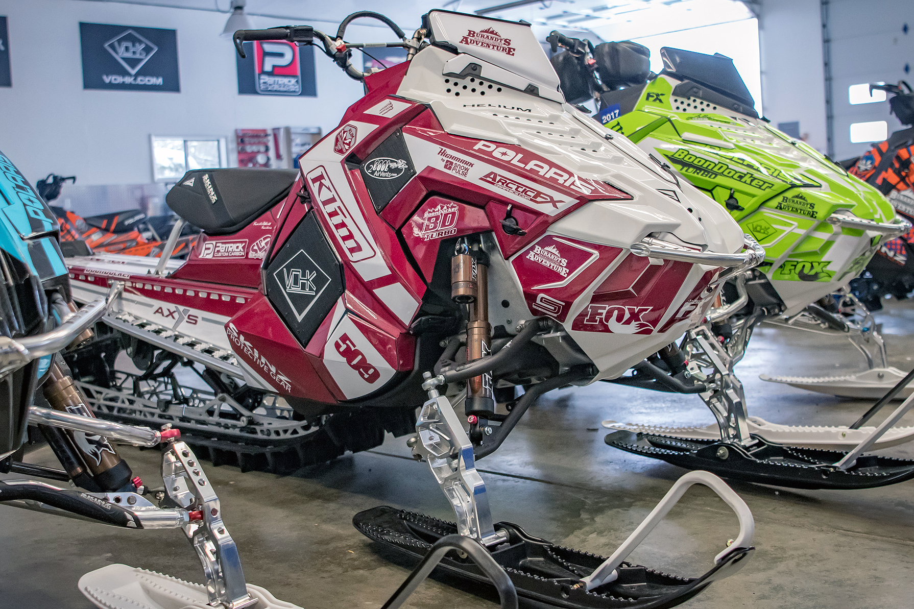 A Polaris Axys Mountain snowmobile with a red and white Ron Burgundy Burandt Vista custom vinyl wrap.