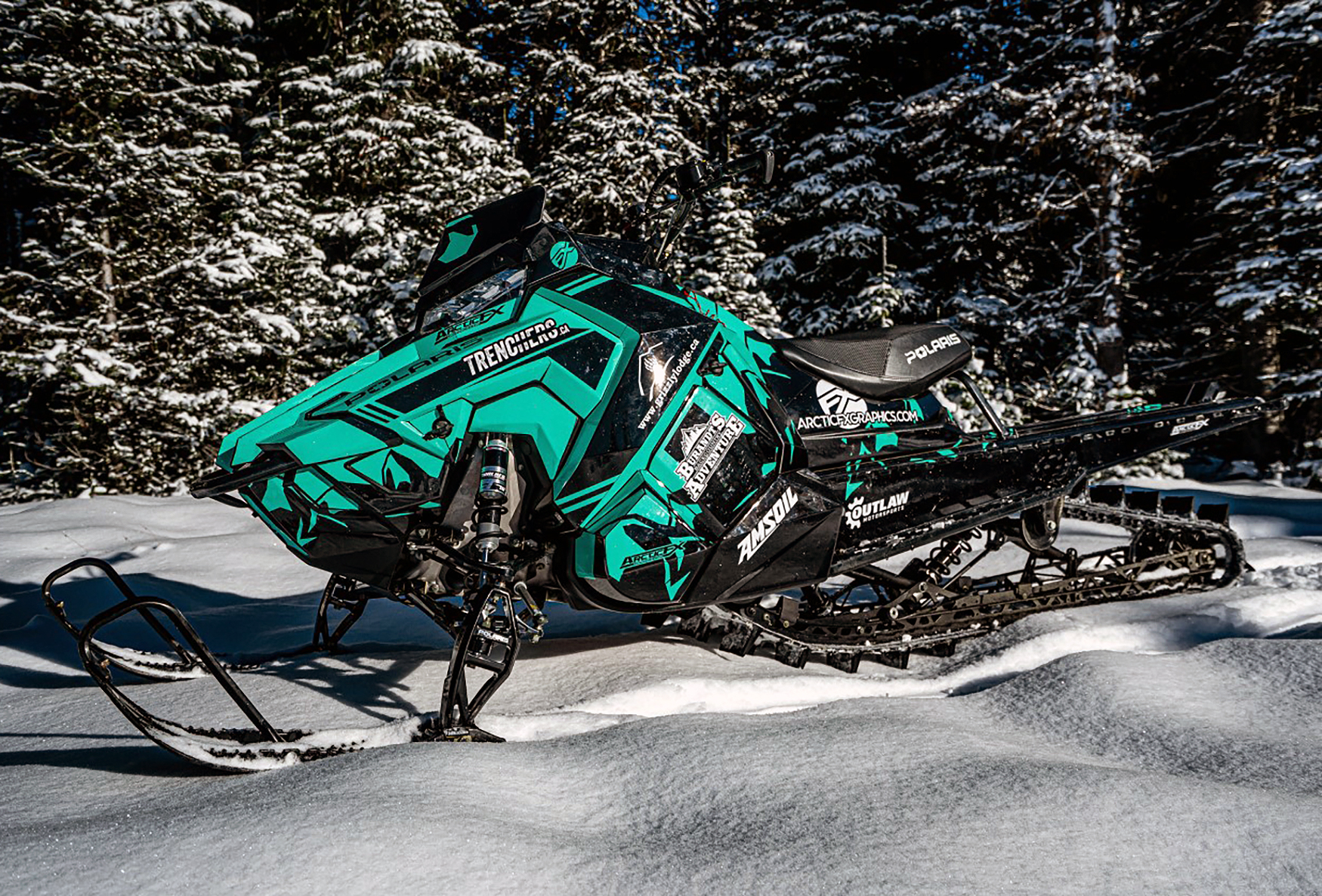 A Polaris Axys Mountain snowmobile with a white, aqua, and black Burandt Vista custom vinyl wrap.