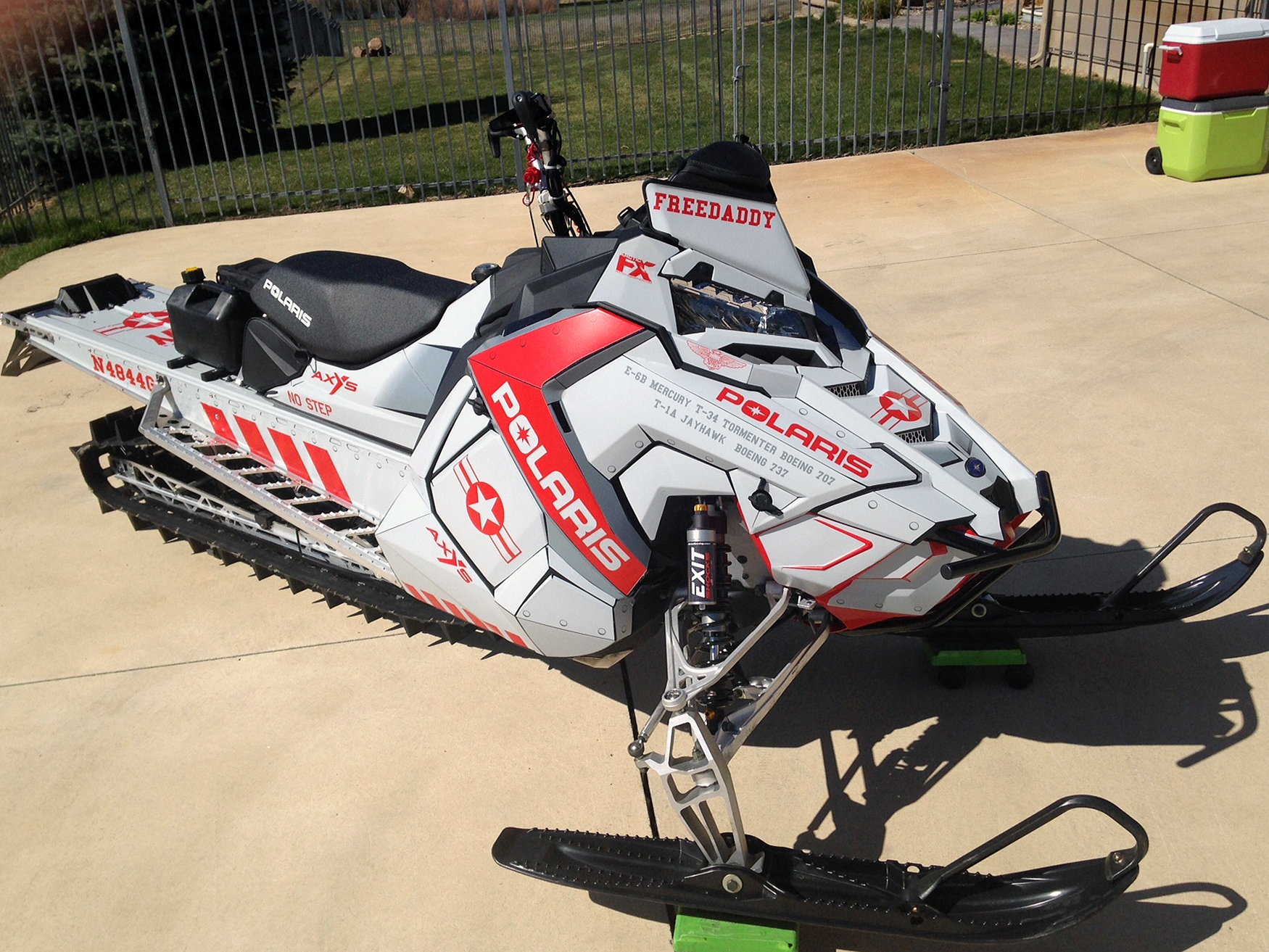 A Polaris Axys Mountain snowmobile with a gray and red Fighter Plane custom vinyl wrap.