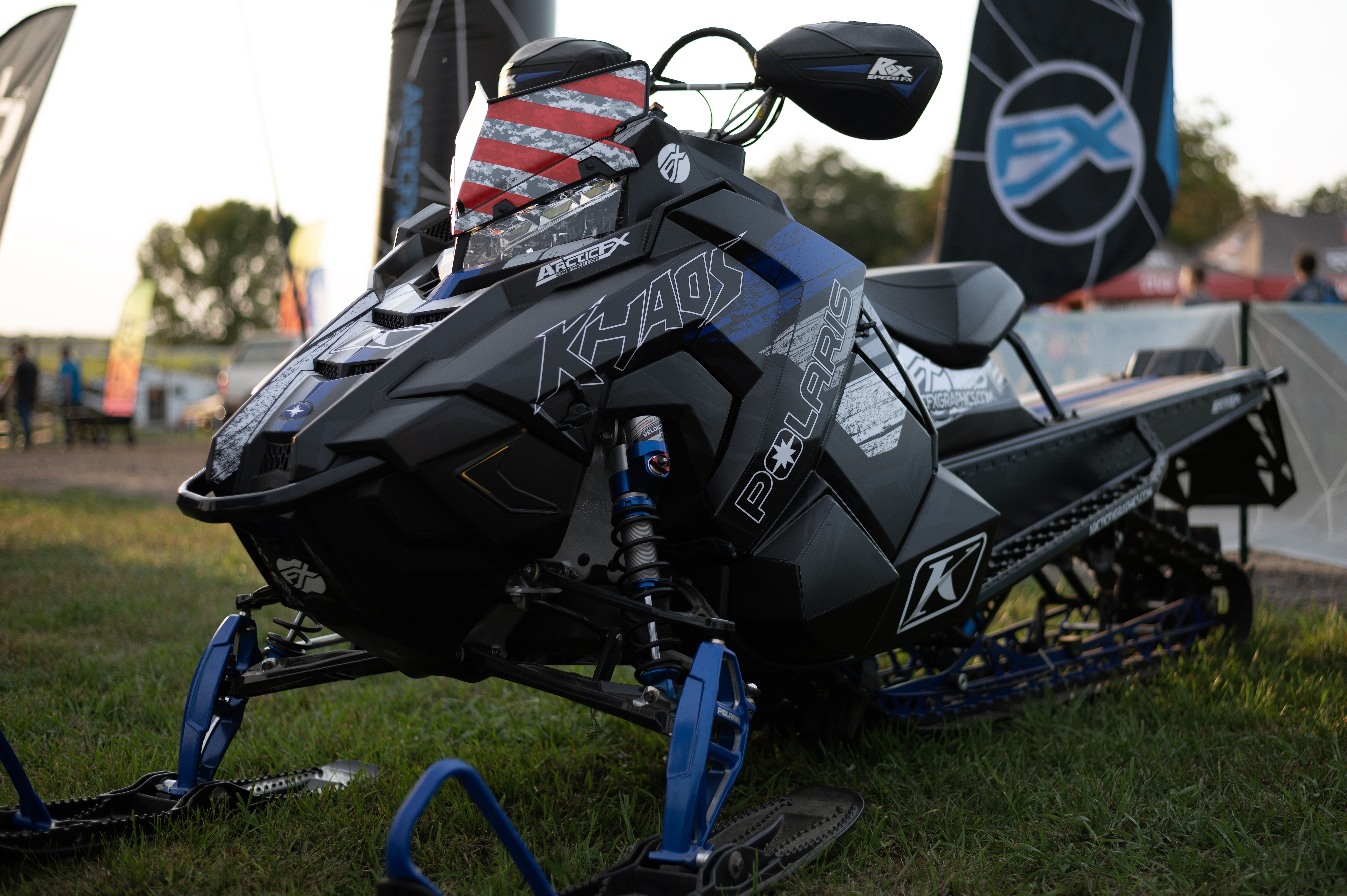 A Polaris Axys Mountain snowmobile with a blue, black, and gun metal RR Ransom custom vinyl wrap.