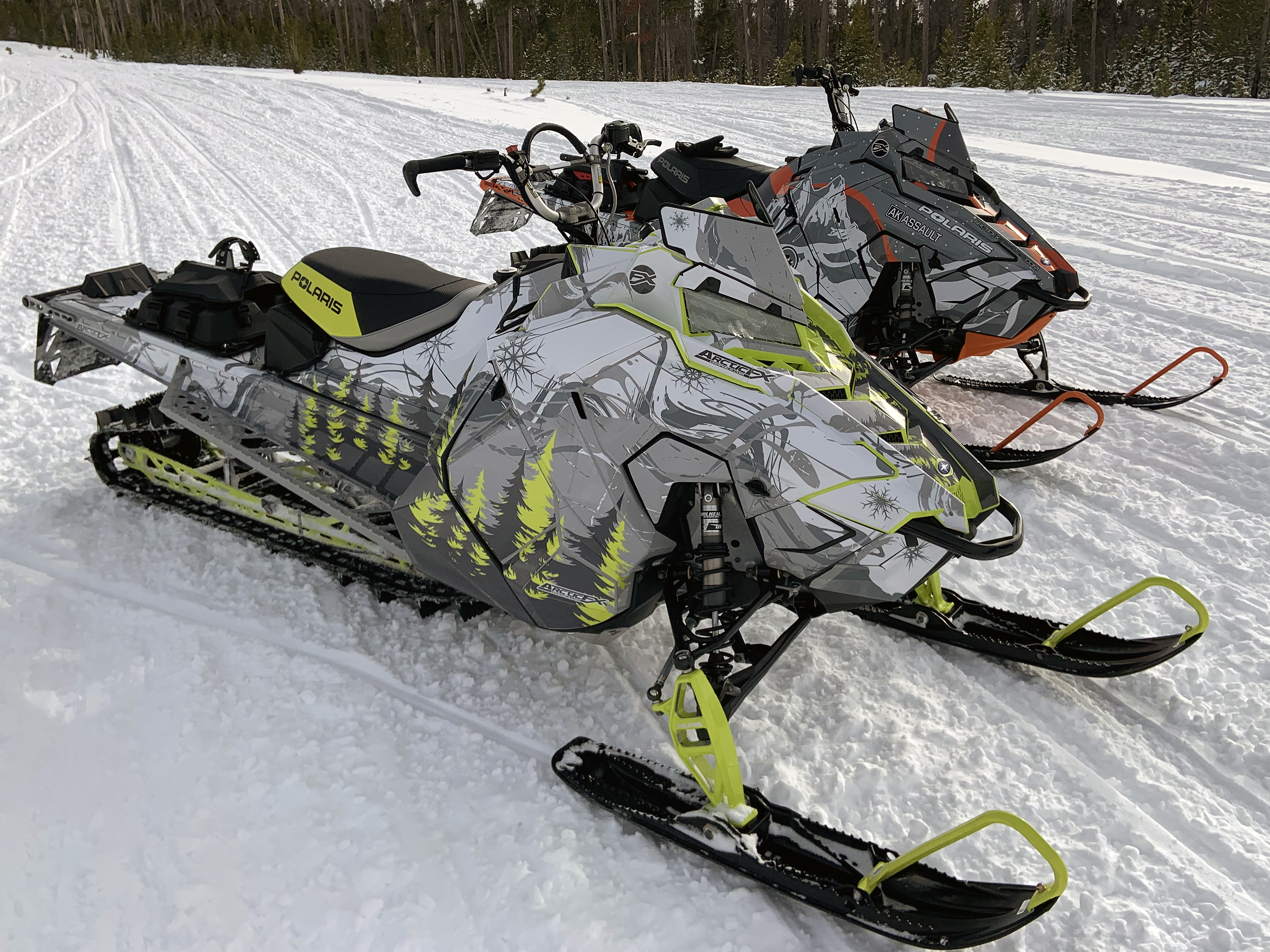 A Polaris Axys Mountain snowmobile with a lime squeeze, gray, and white Sub Zero custom vinyl wrap.