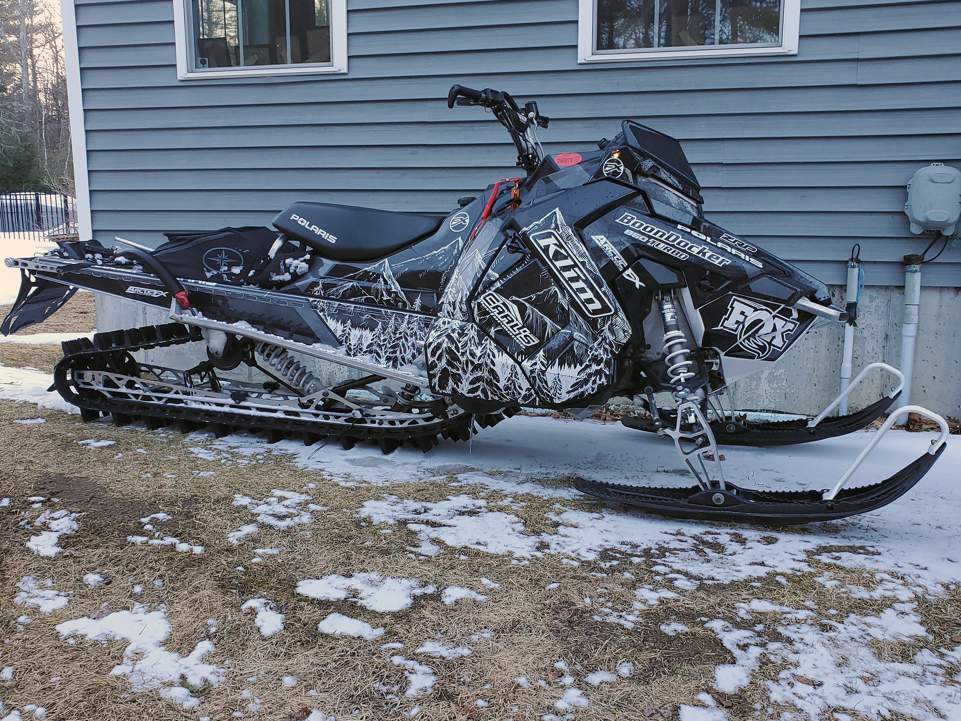 A Polaris Axys Mountain snowmobile with a black and white Andy Thomas Peaked custom vinyl wrap.