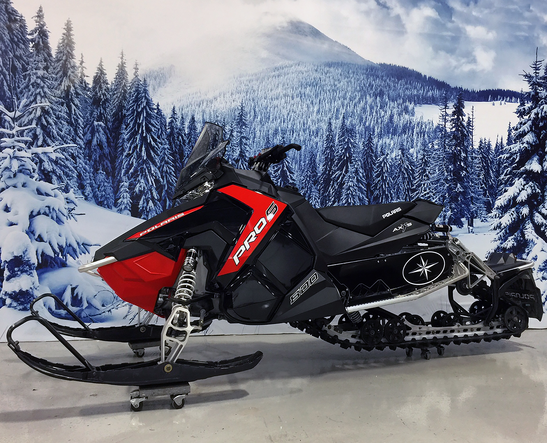 A Polaris Axys Trail snowmobile with a black and white star tunnel custom vinyl wrap.