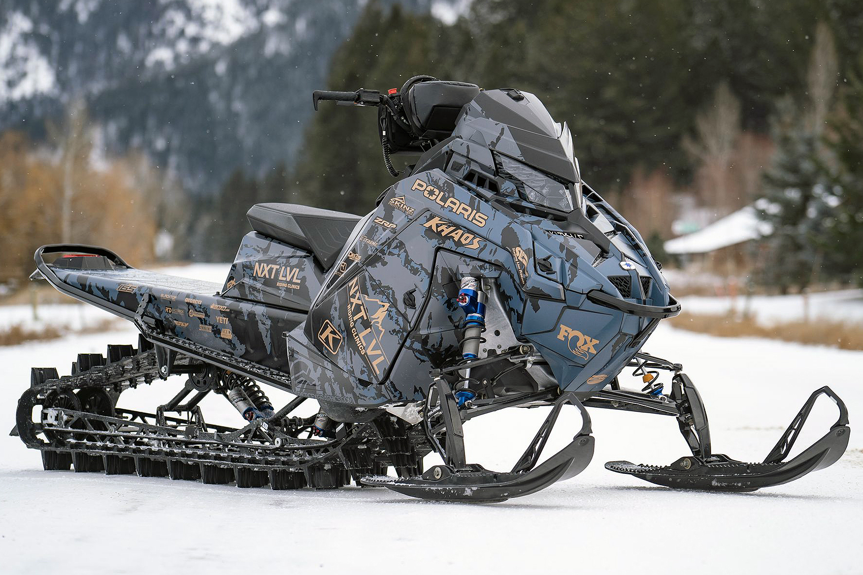 A Polaris Matryx Mountain snowmobile with a gray, tan, and black Adams Inversion custom vinyl wrap.