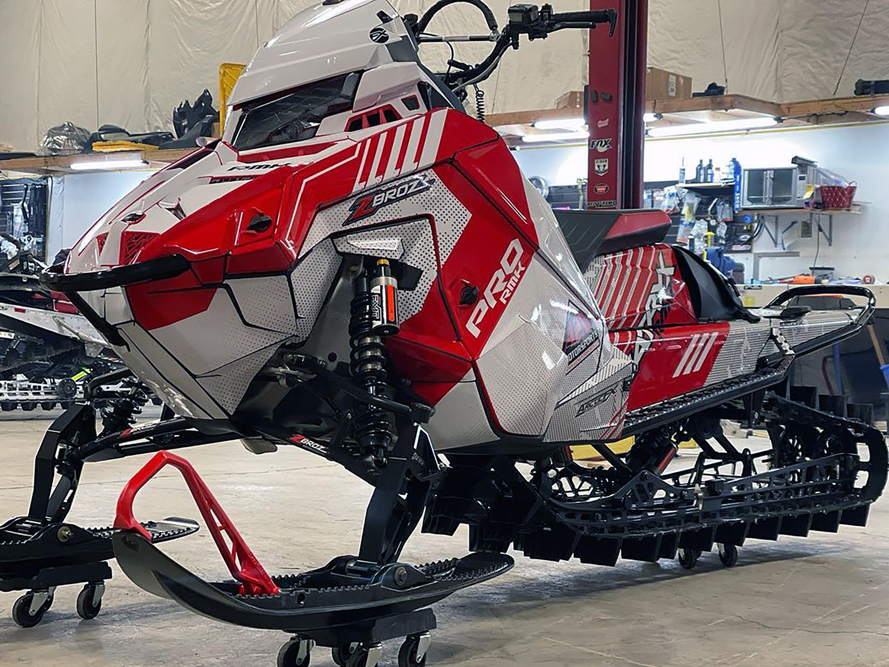A Polaris Matryx Mountain snowmobile with a red and white Armada custom vinyl wrap.