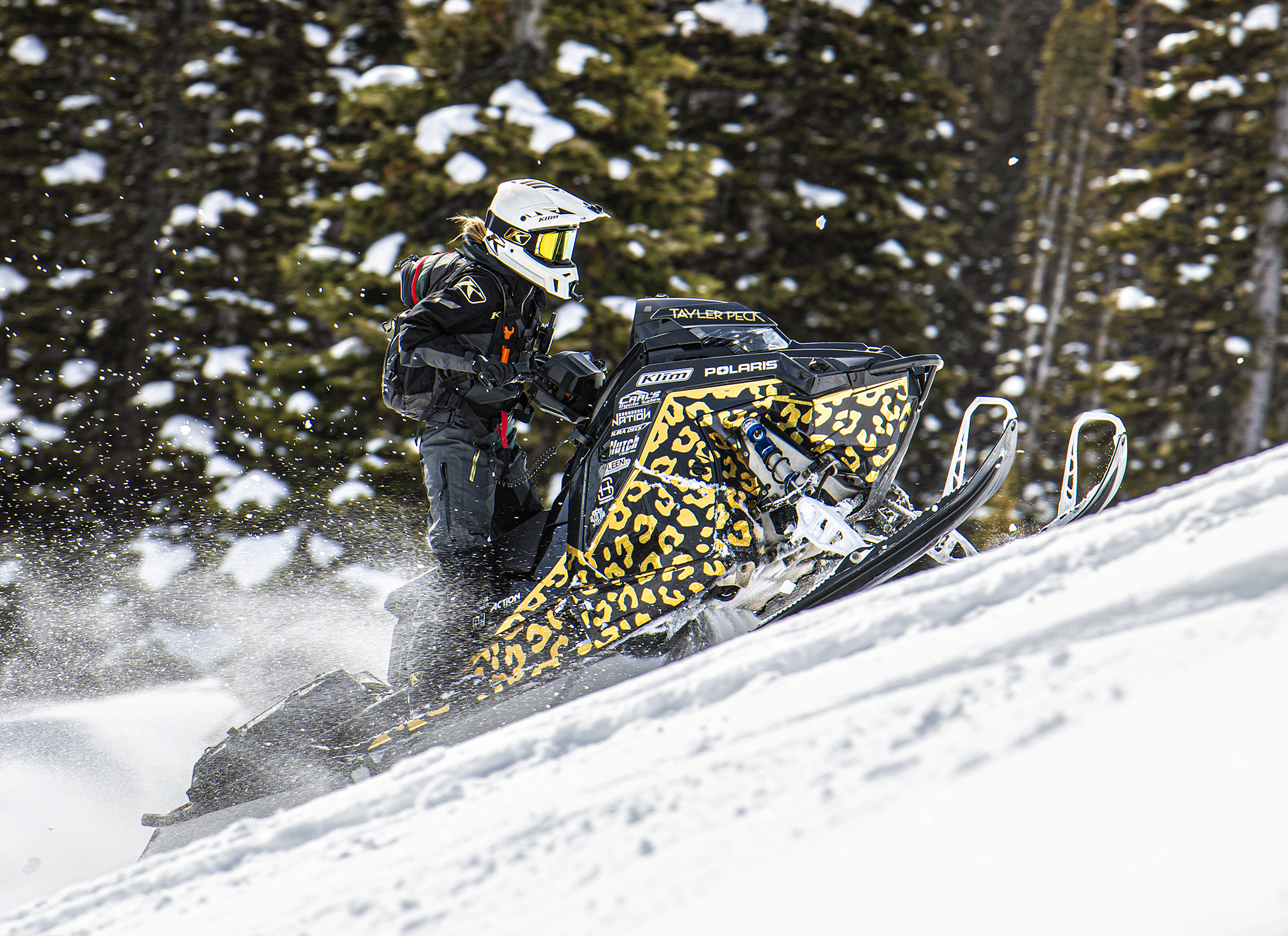 A Polaris Matryx Mountain snowmobile with a white, black, and tan Cheetah Pattern custom vinyl wrap.