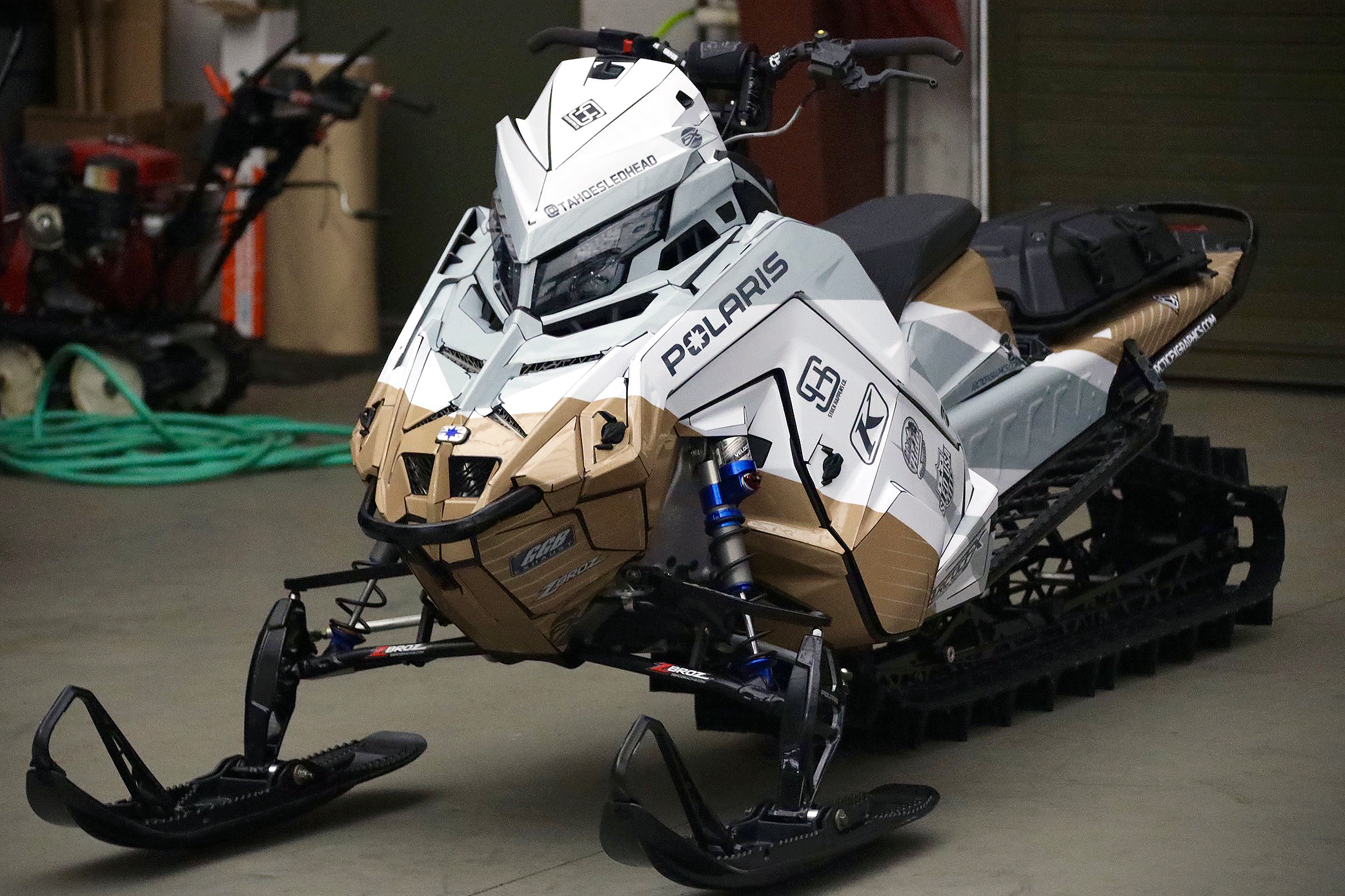 A Polaris Matryx Mountain snowmobile with a white and tan Curtis Ascent custom vinyl wrap.
