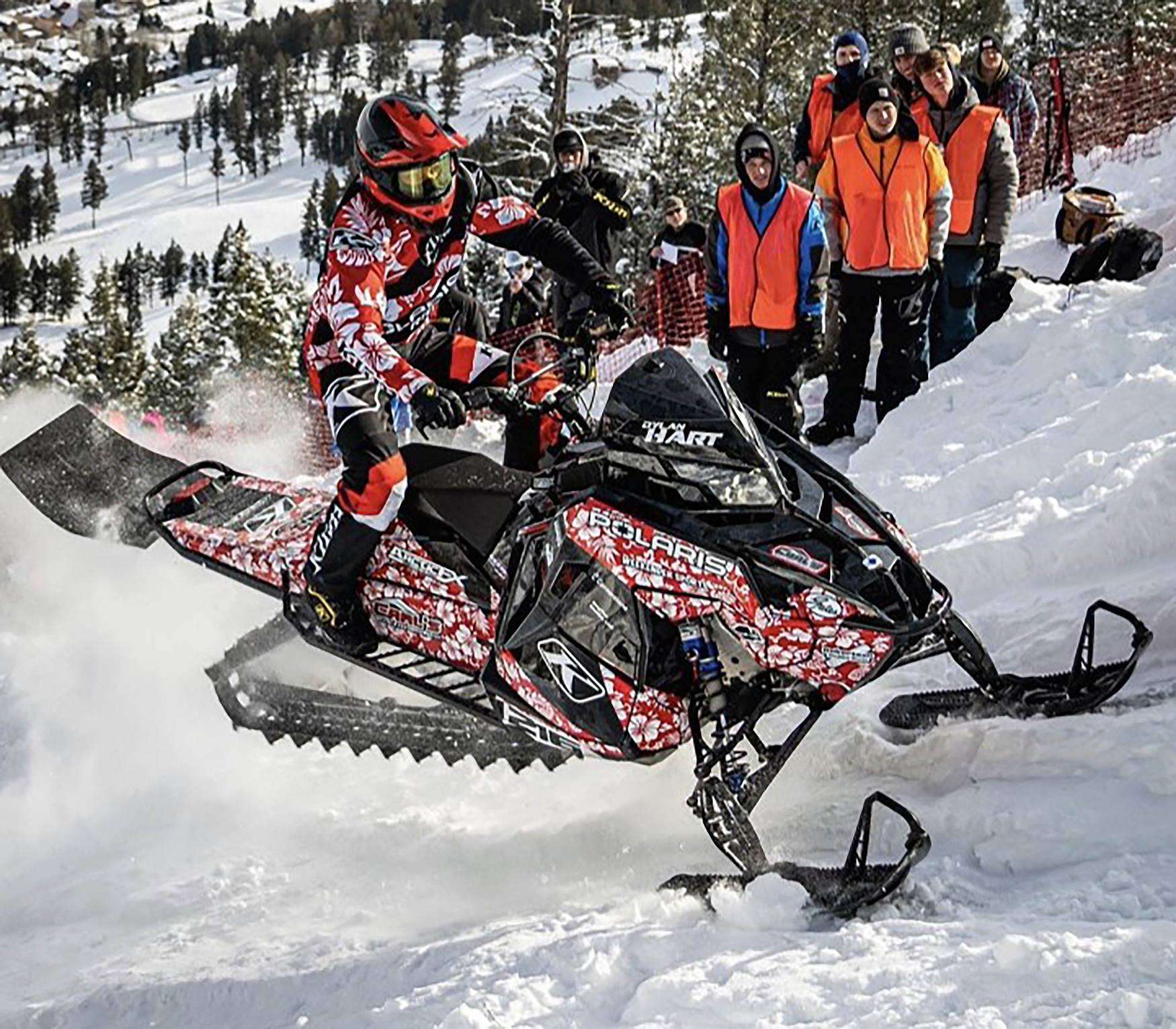 A Polaris Matryx Mountain snowmobile with a red, black, and white Dylan Hart custom vinyl wrap.