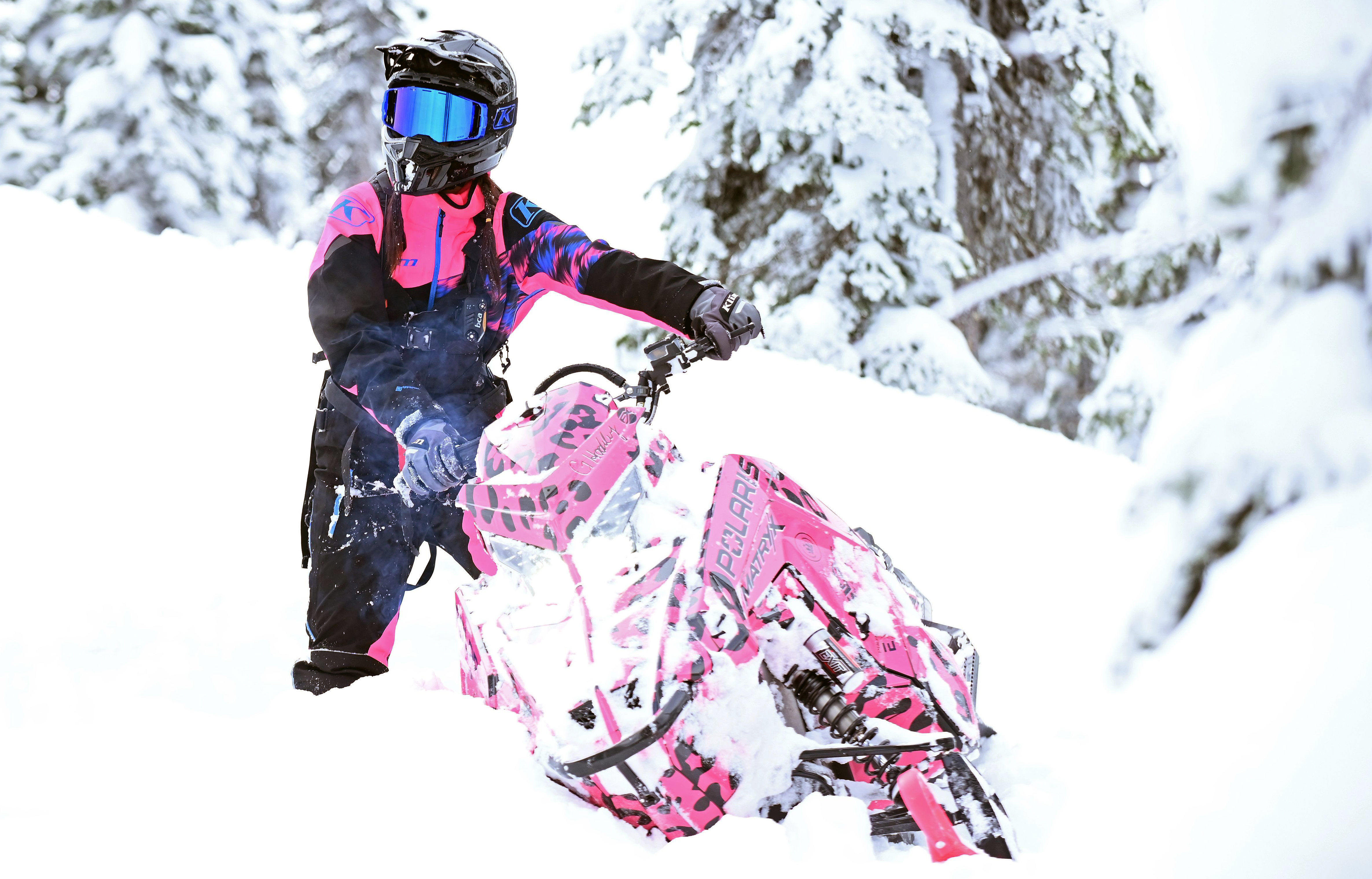 A Polaris Matryx Mountain snowmobile with a pink and black Hockley Cheetah custom vinyl wrap.