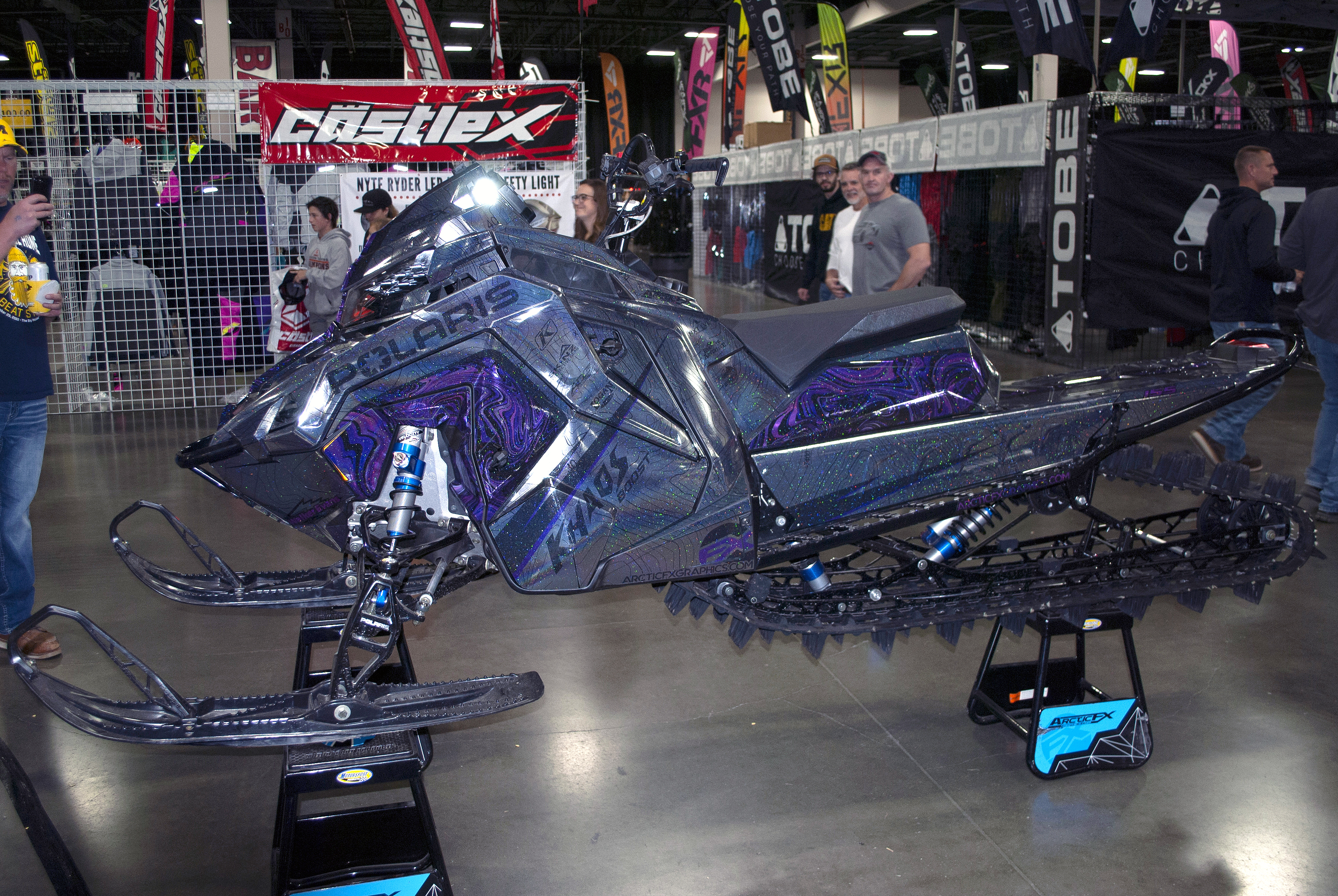 A Polaris Matryx Mountain snowmobile with a purple, black, and chrome Jordan custom vinyl wrap.