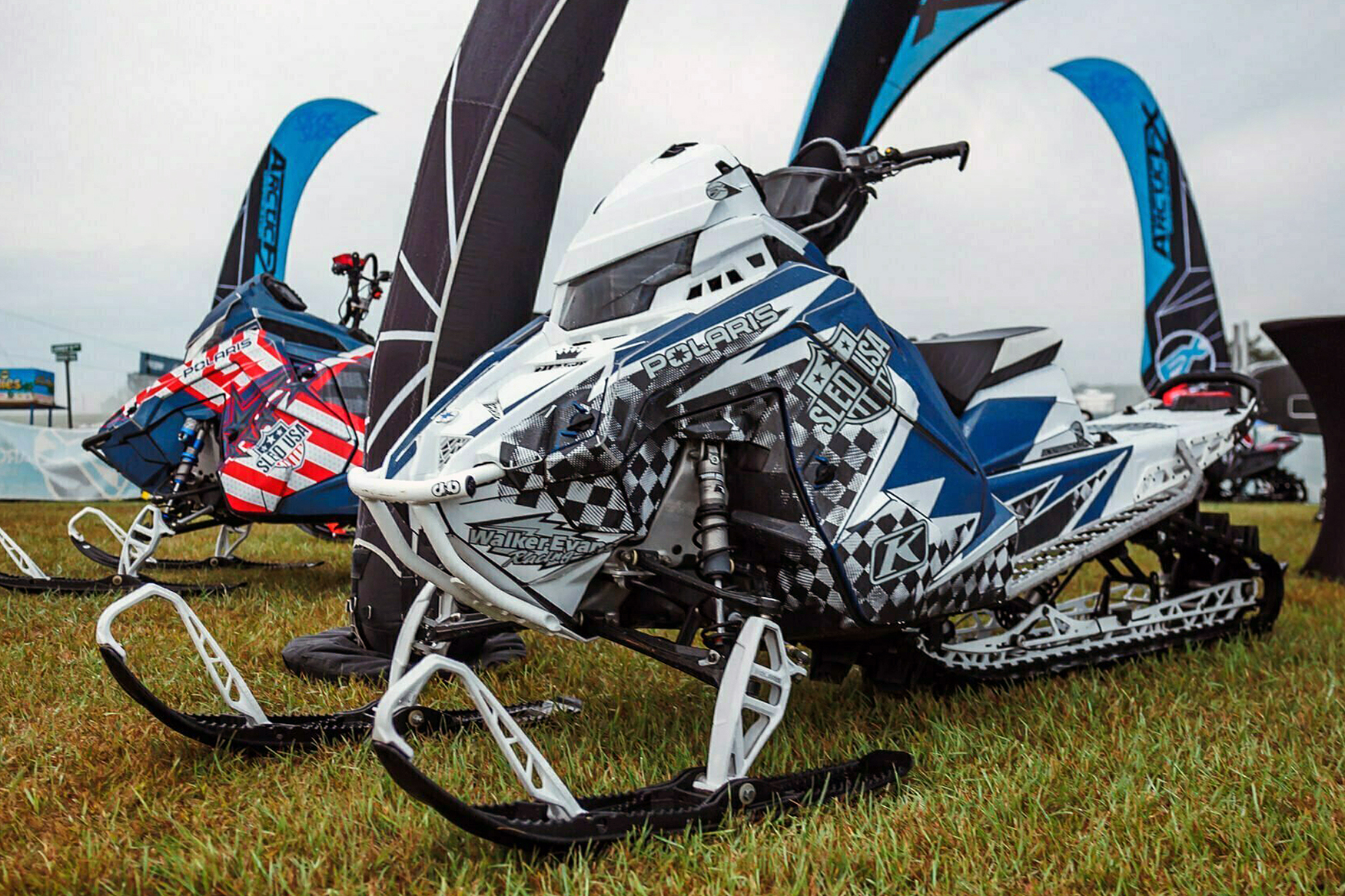 A Polaris Matryx Mountain snowmobile with a black, blue and white KC711 Ignition custom vinyl wrap.