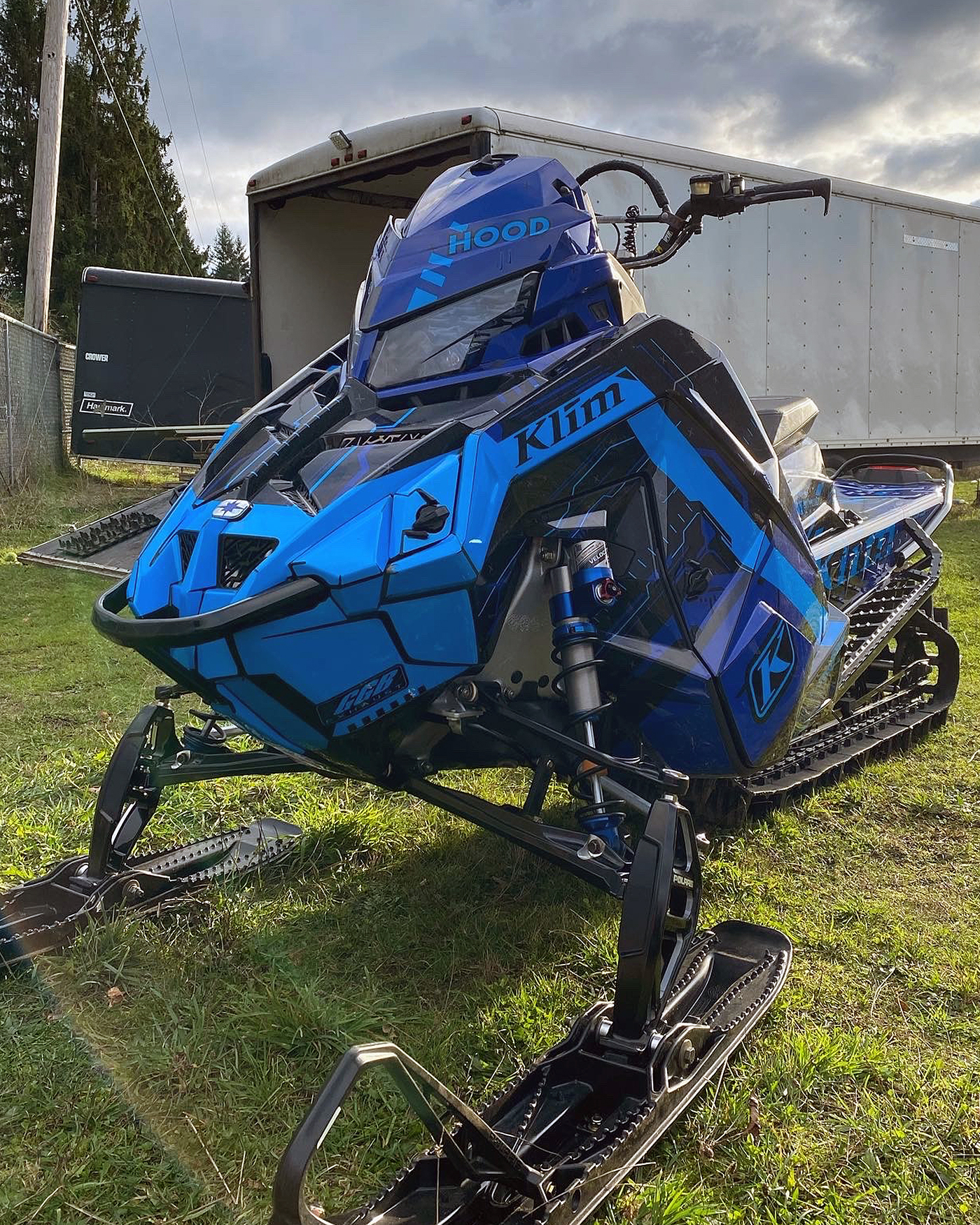A Polaris Matryx Mountain snowmobile with a blue and black Klim Recoil custom vinyl wrap.