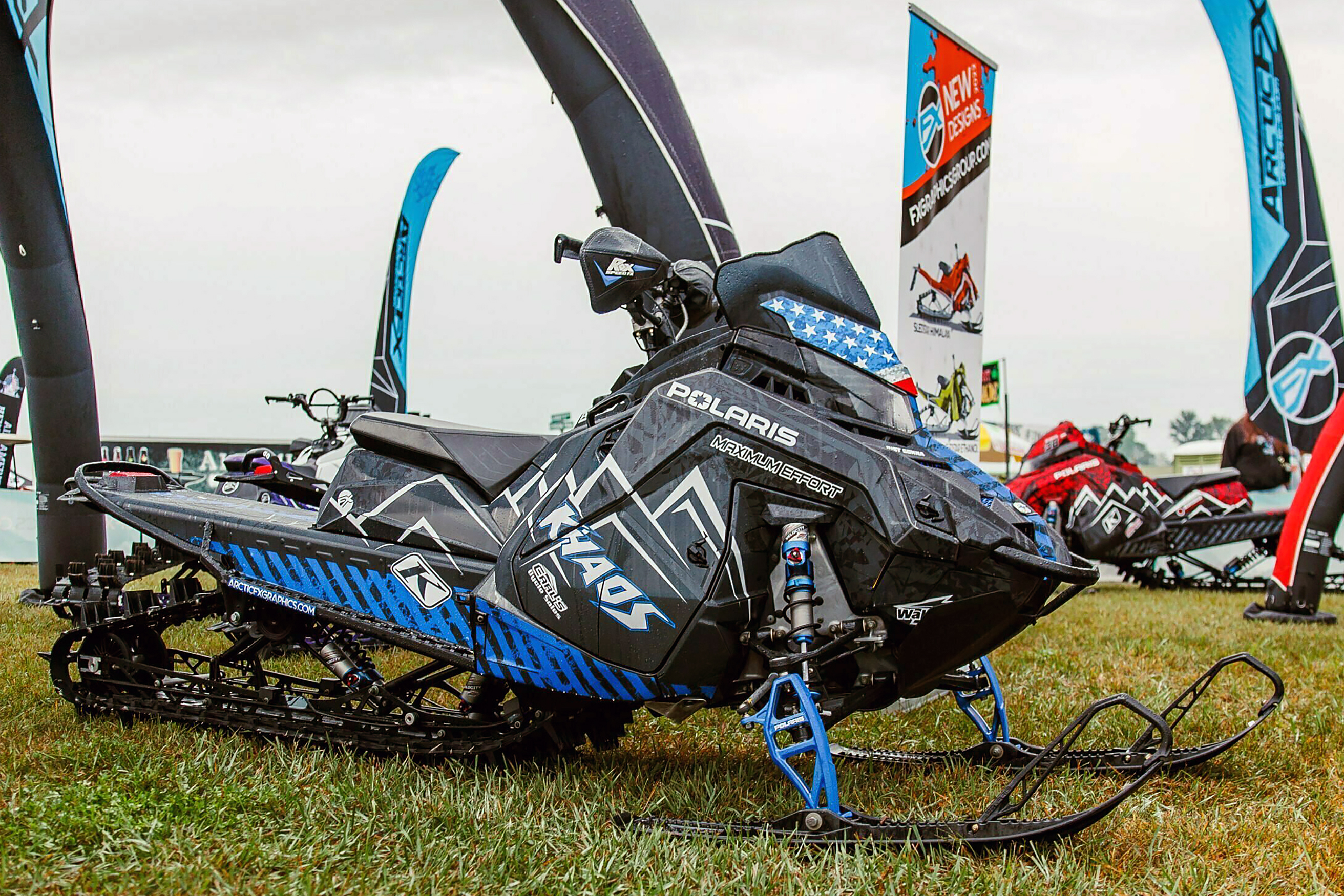 A Polaris Matryx Mountain snowmobile with a black, blue and white Peterson Hazard custom vinyl wrap.