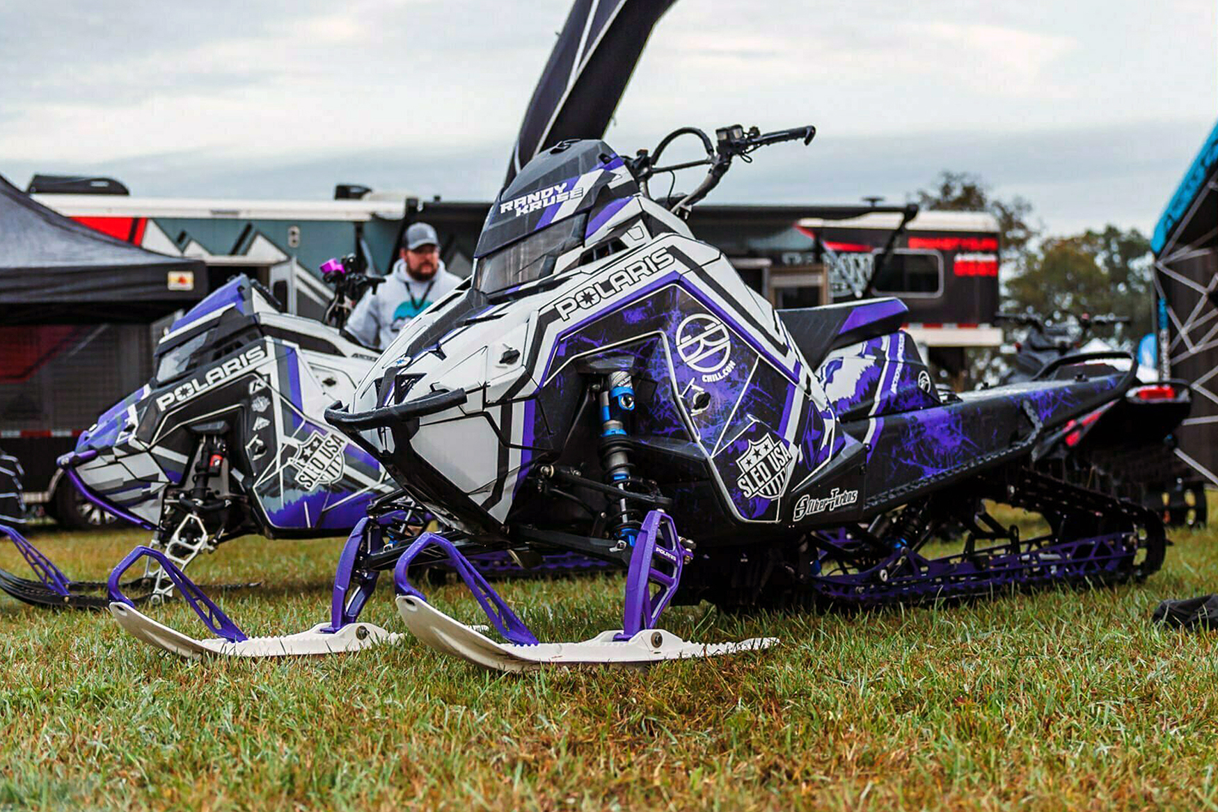A Polaris Matryx Mountain snowmobile with a black, white, and purple Wilford Chilled custom vinyl wrap.