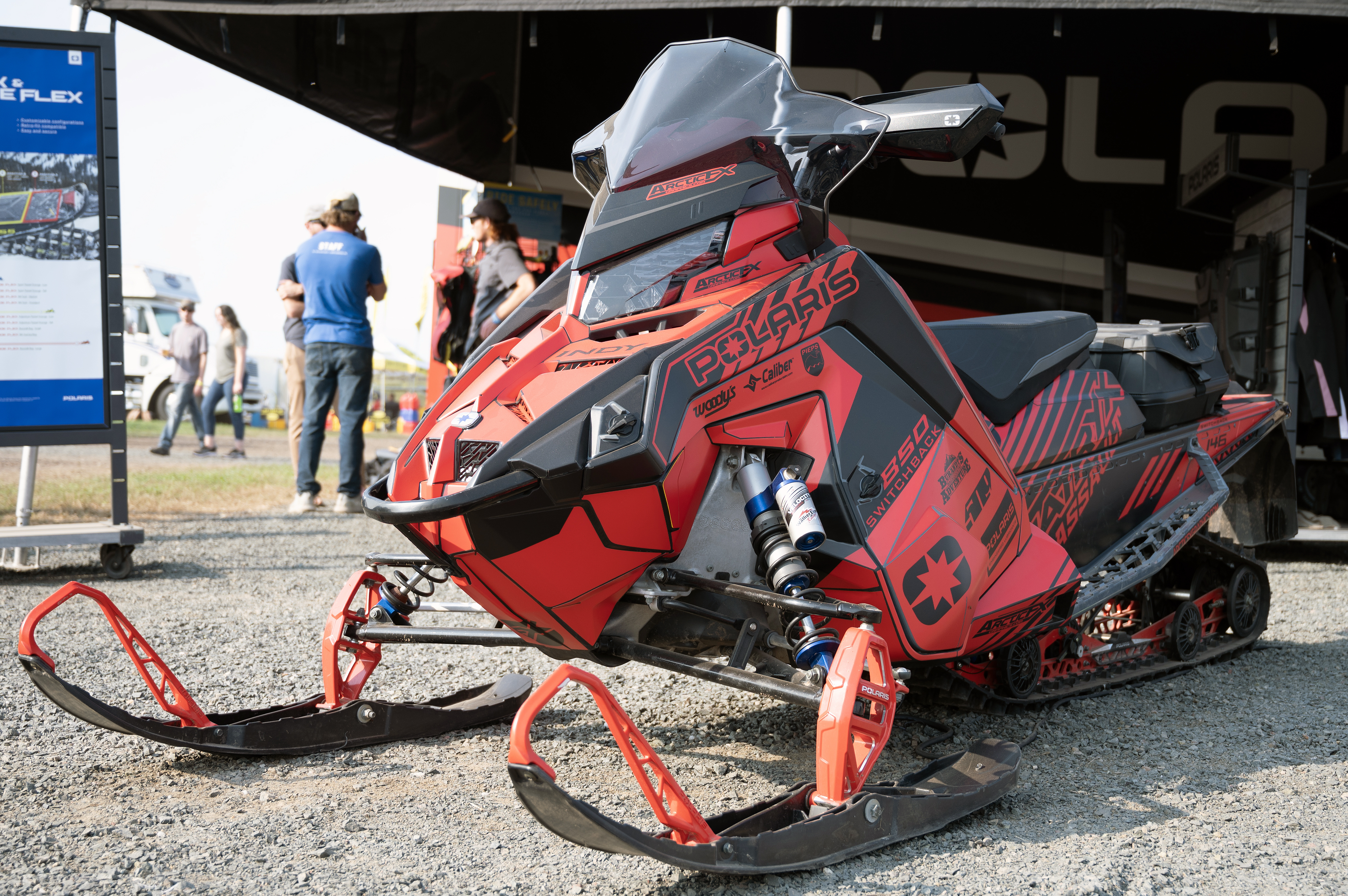 A Polaris Matryx Trail snowmobile with a red and black Armada custom vinyl wrap.