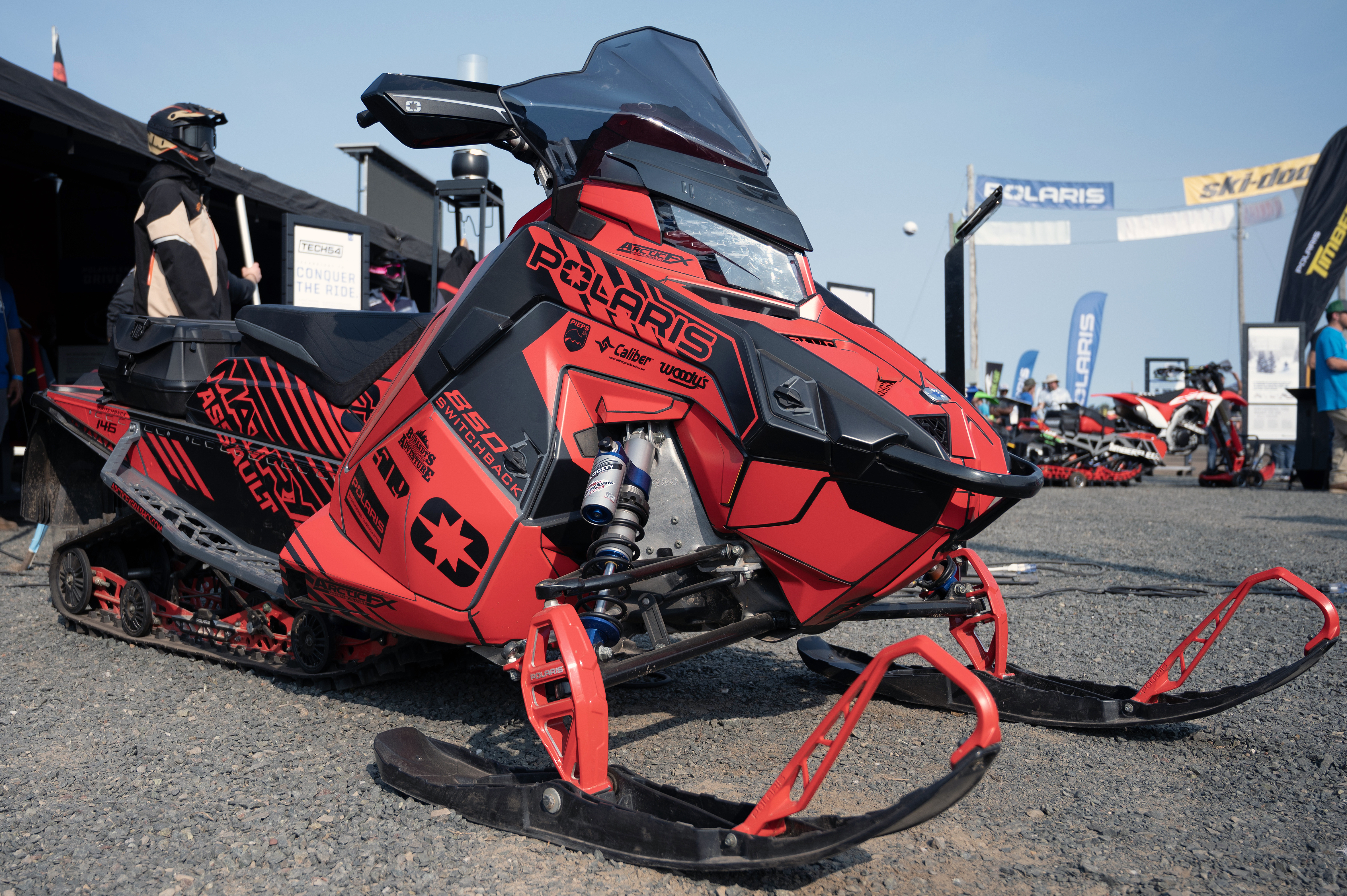 A Polaris Matryx Trail snowmobile with a red and black Armada custom vinyl wrap.
