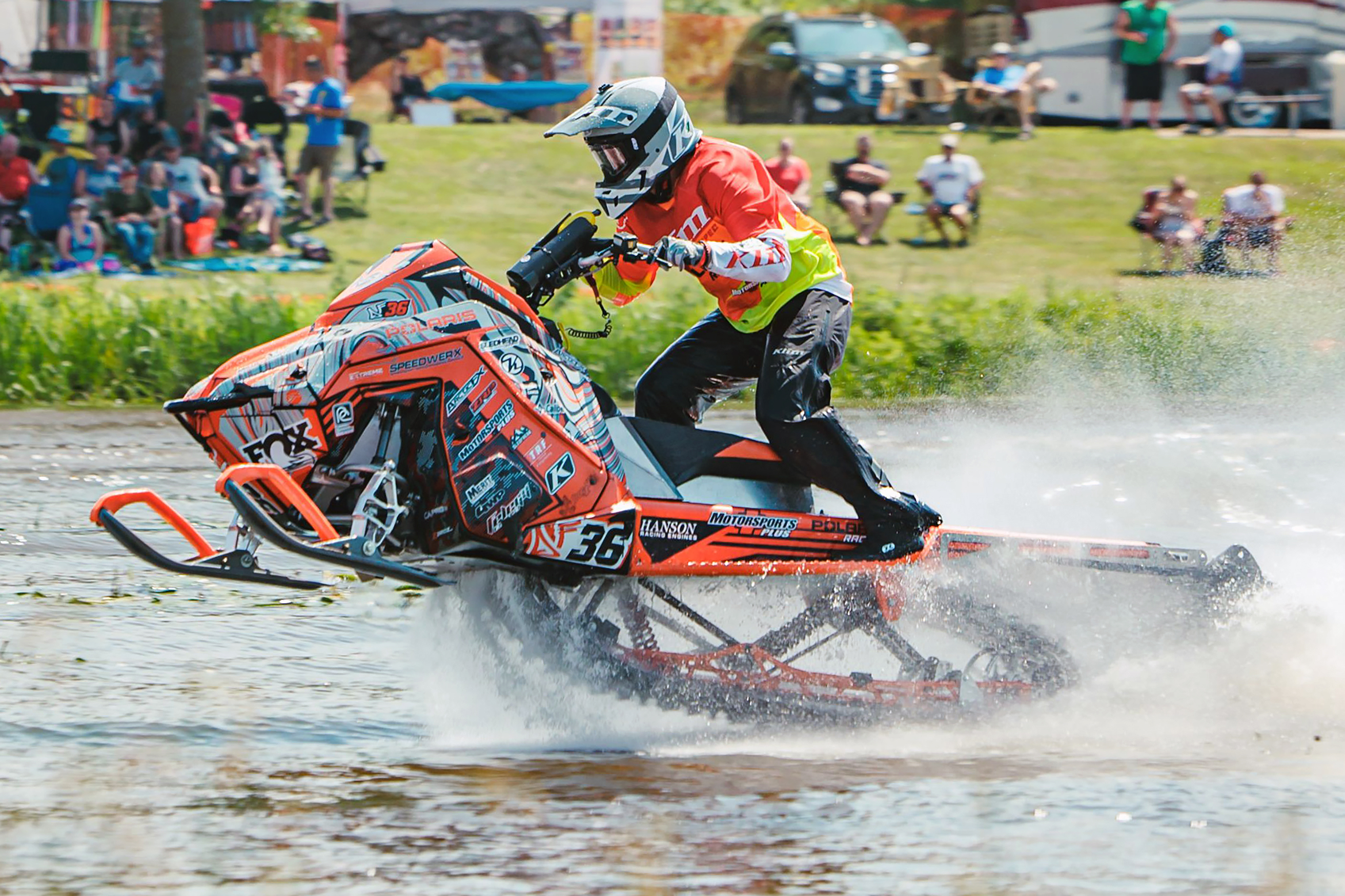 A Polaris Matryx Trail snowmobile with a white, orange, and black DF36 Psych custom vinyl wrap.