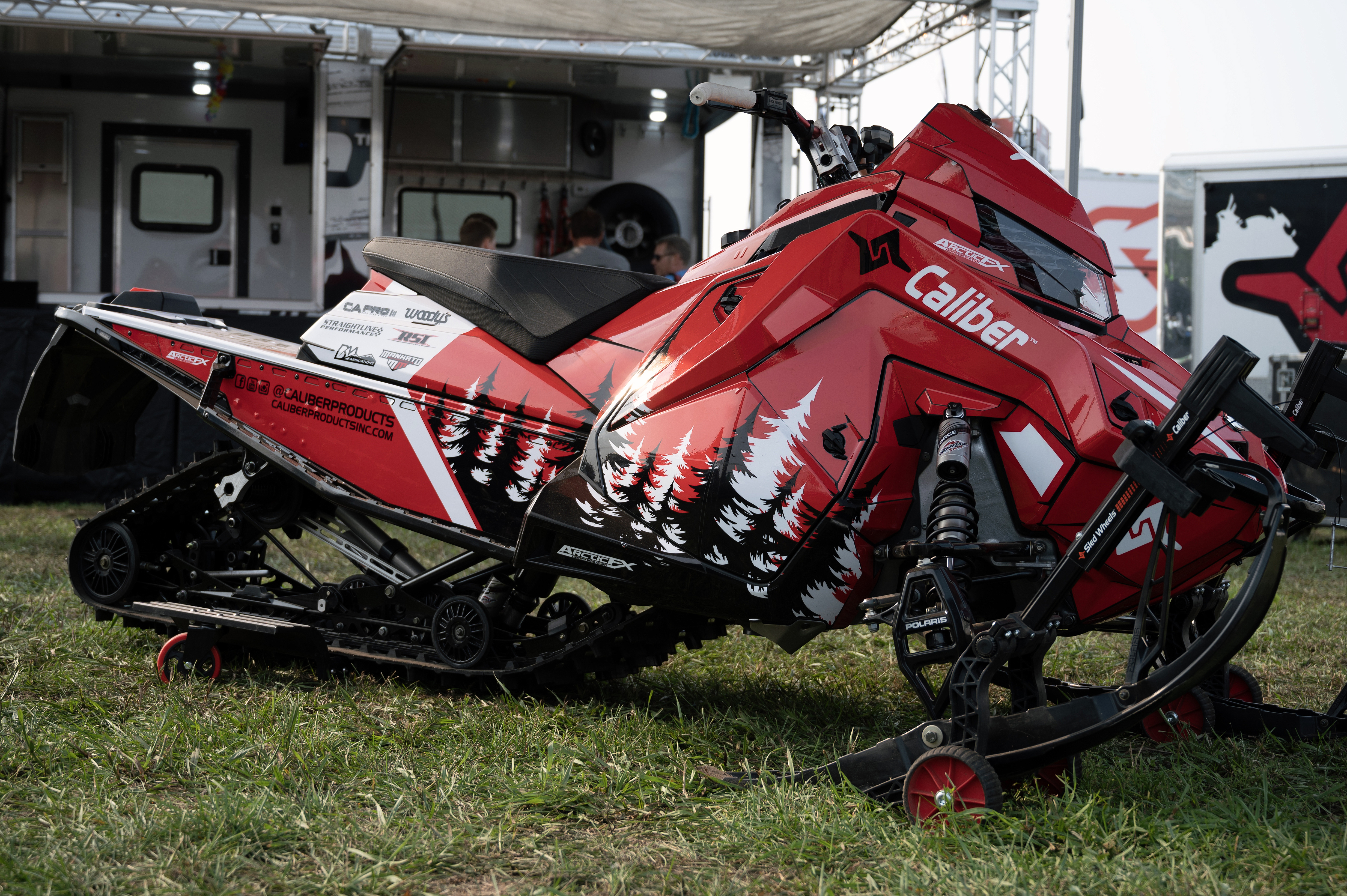 A Polaris Matryx Trail snowmobile with a white, red, and black Sub Zero custom vinyl wrap.