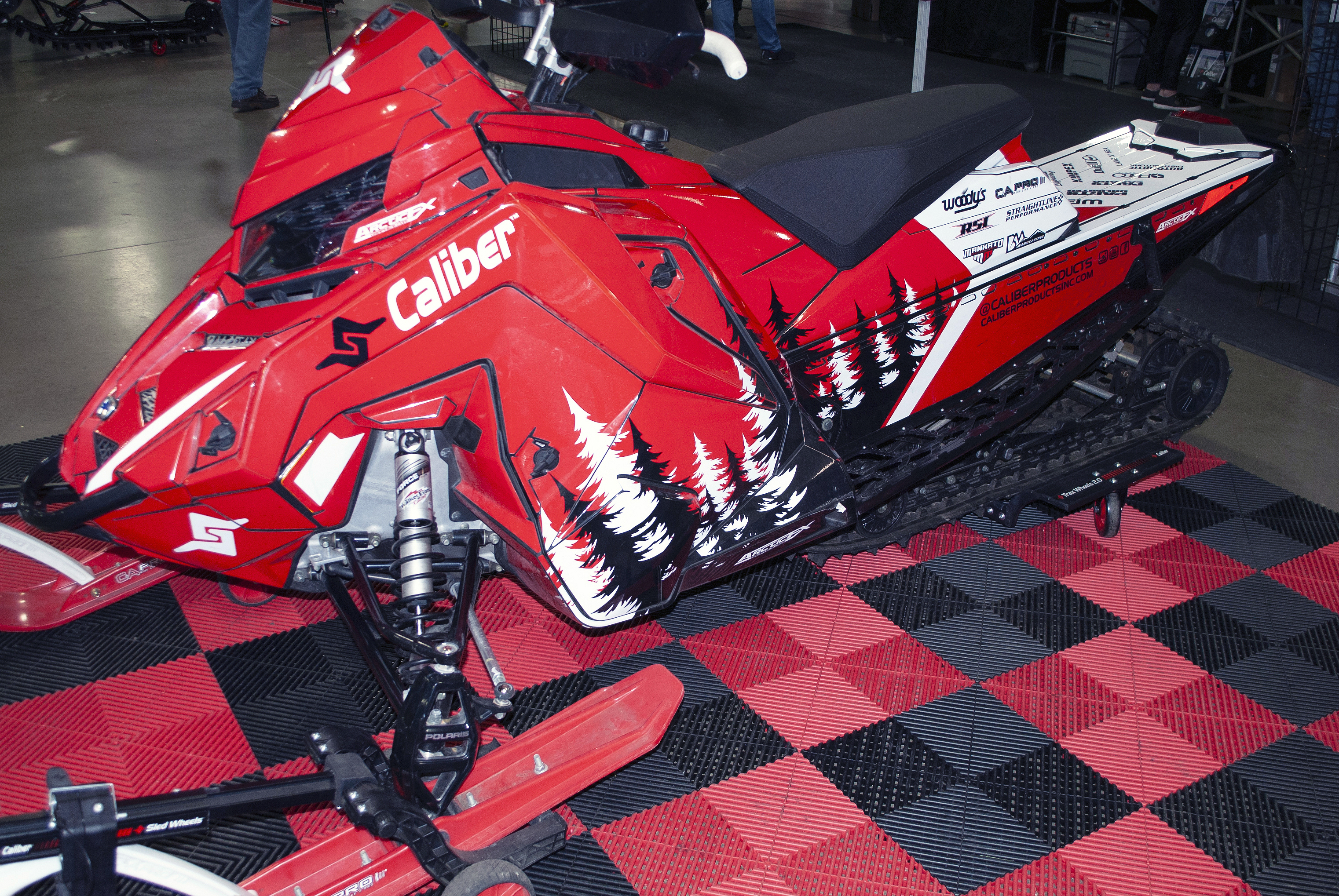 A Polaris Matryx Trail snowmobile with a white, red, and black Sub Zero custom vinyl wrap.