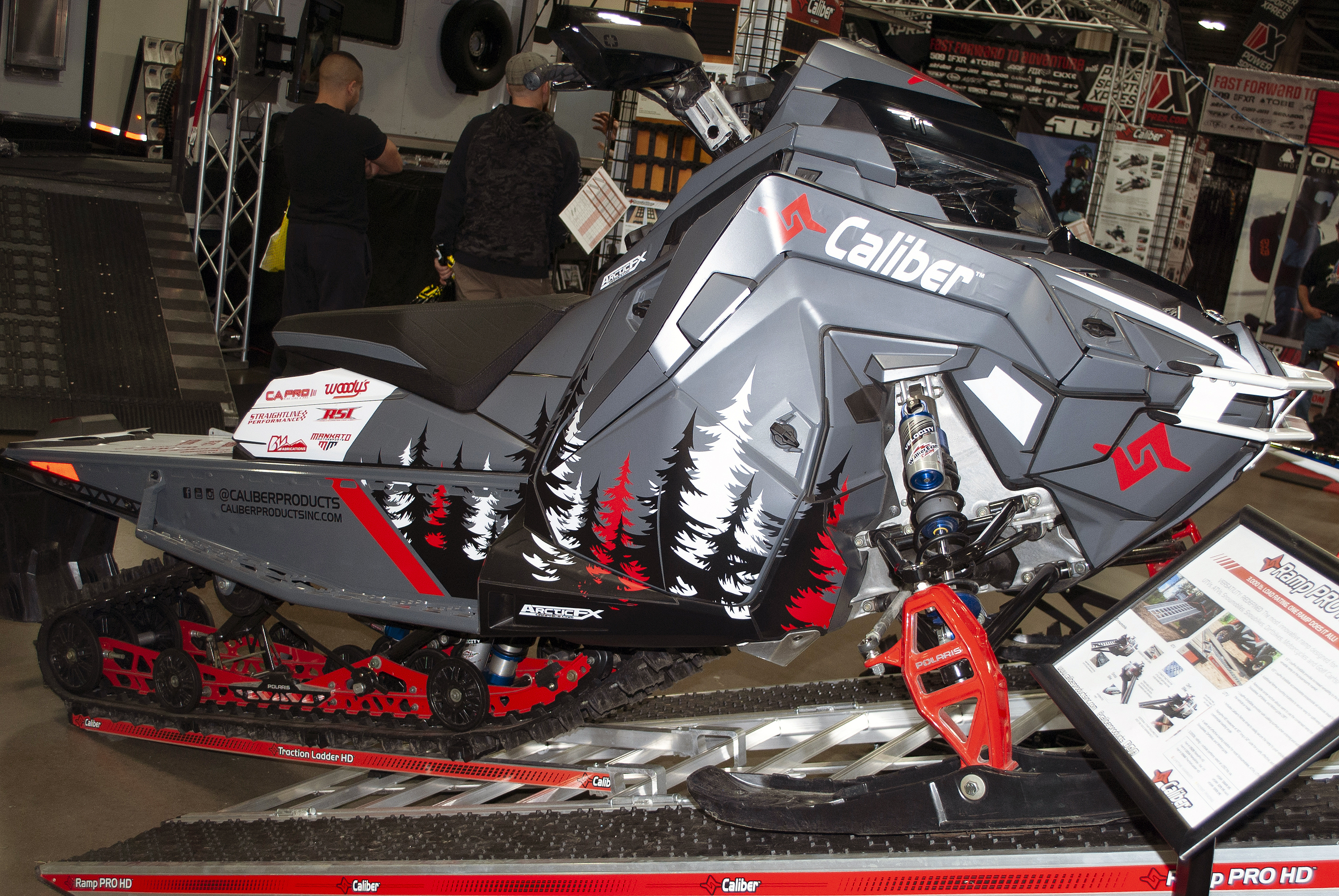 A Polaris Matryx Trail snowmobile with a gray, white, red, and black Sub Zero custom vinyl wrap.