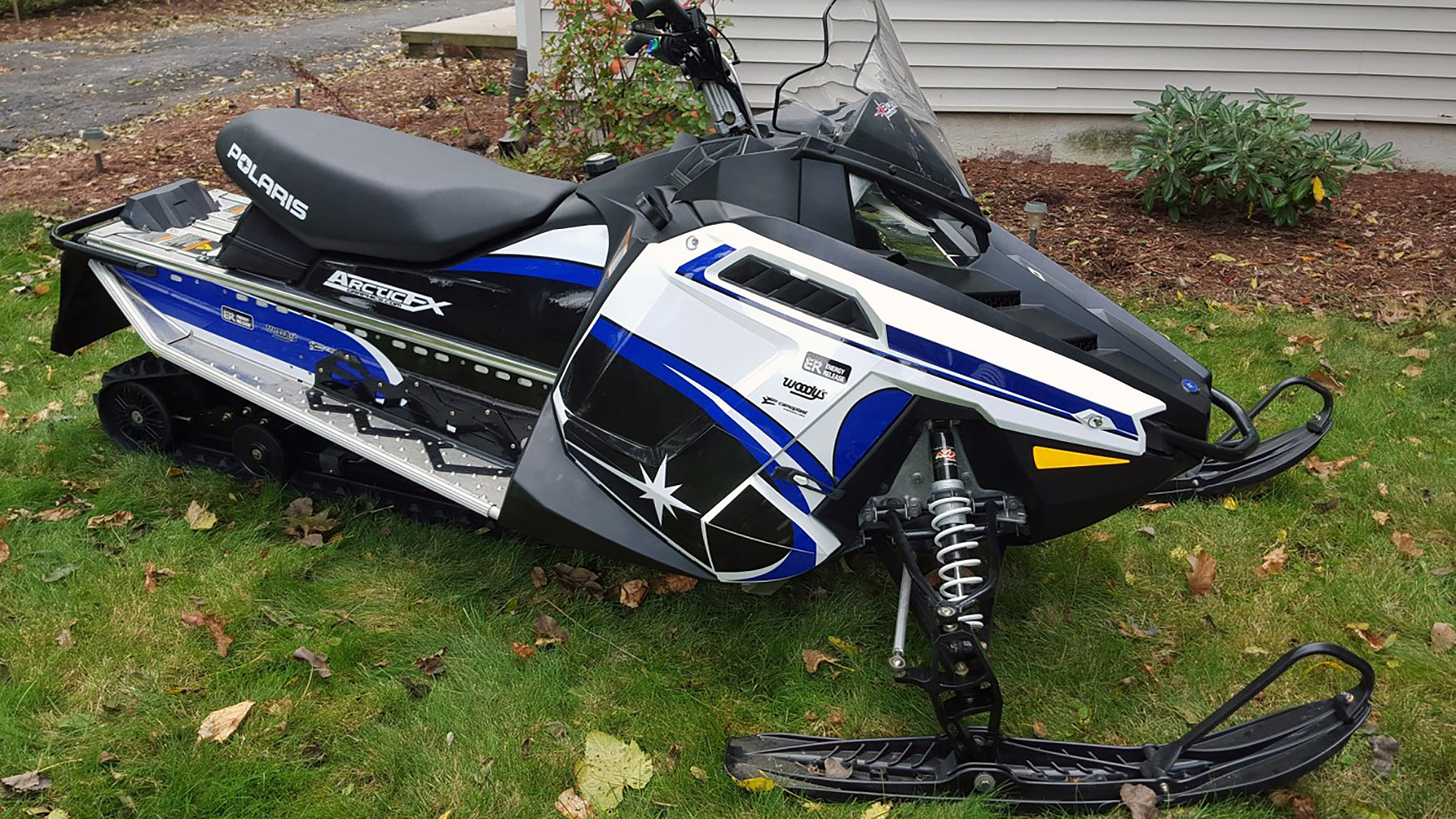 A Polaris Pro-Ride snowmobile with a blue, black, and white Retro Star custom vinyl wrap.