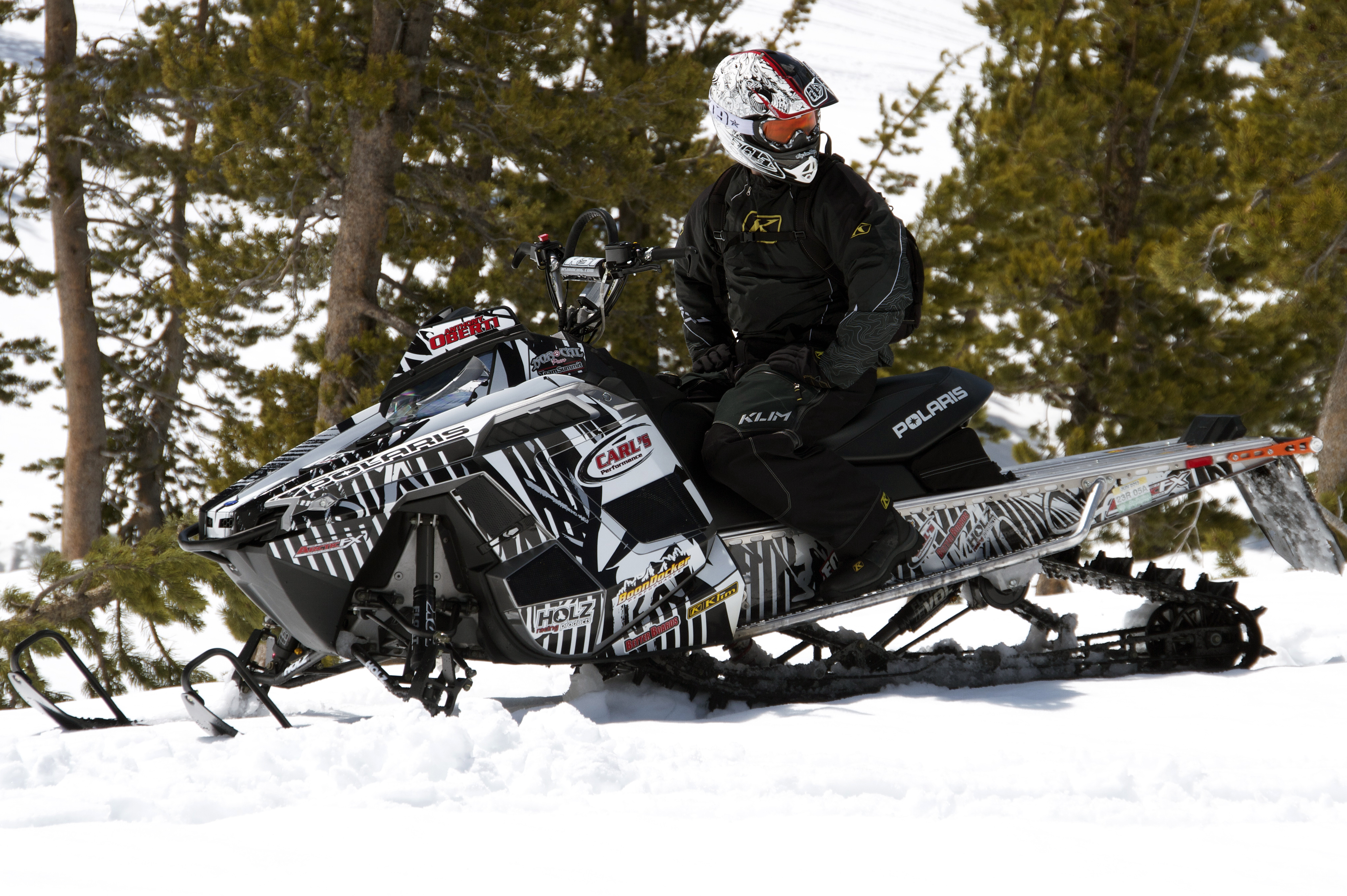 A Polaris Pro-Ride snowmobile with a white and black Adams Scrib custom vinyl wrap.