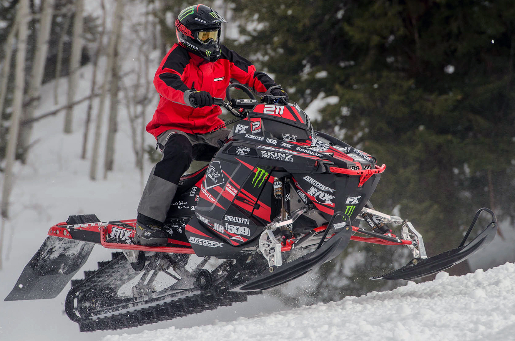 A Polaris Pro-Ride snowmobile with a red and black Burandt Evolution custom vinyl wrap.