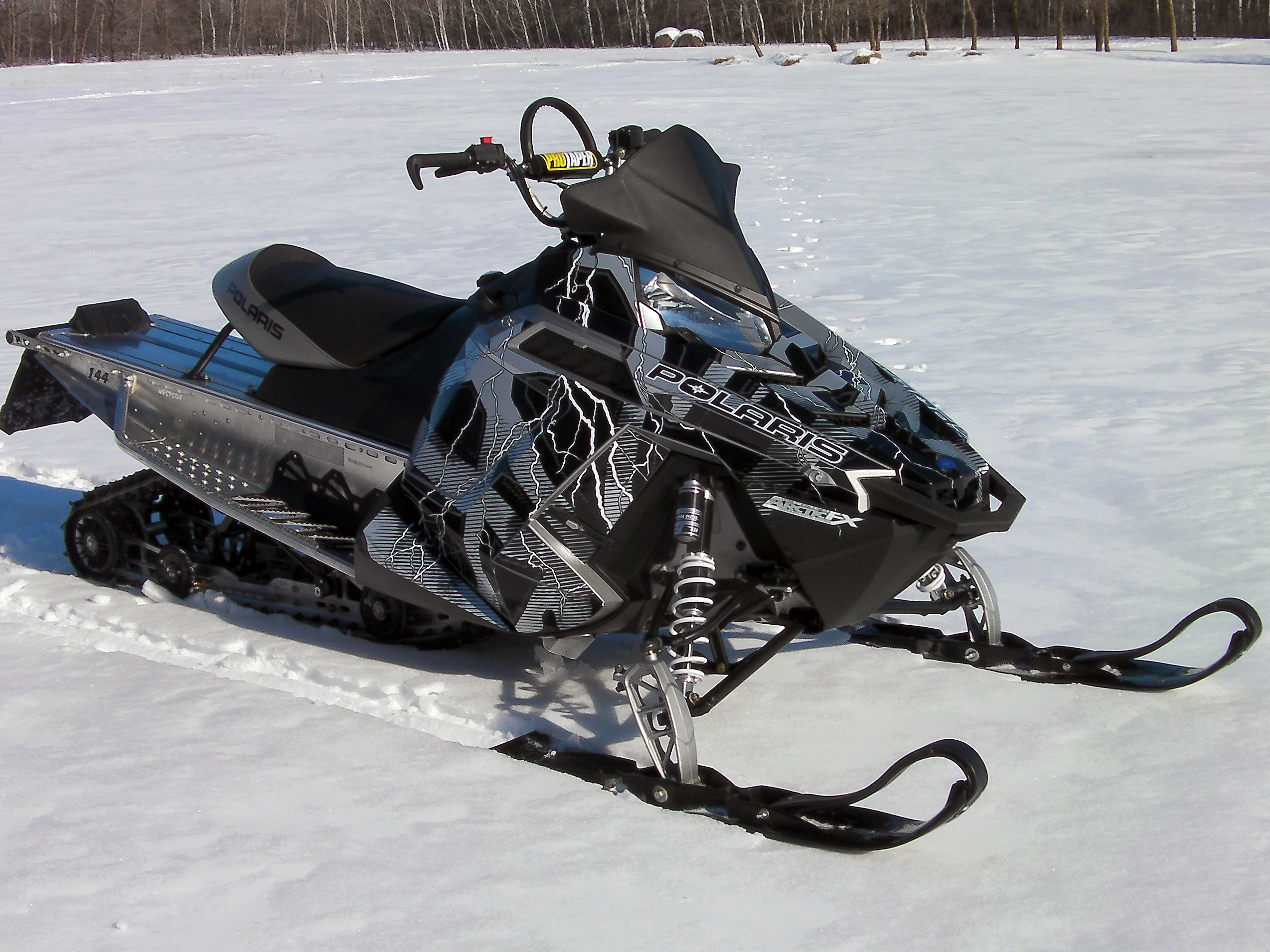 A Polaris Pro-Ride snowmobile with a gray, white, and black Hard Rain custom vinyl wrap.