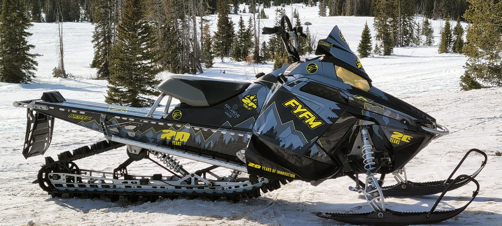 A Polaris Pro-Ride snowmobile with a black, gray, and yellow Klim Legacy custom vinyl wrap.