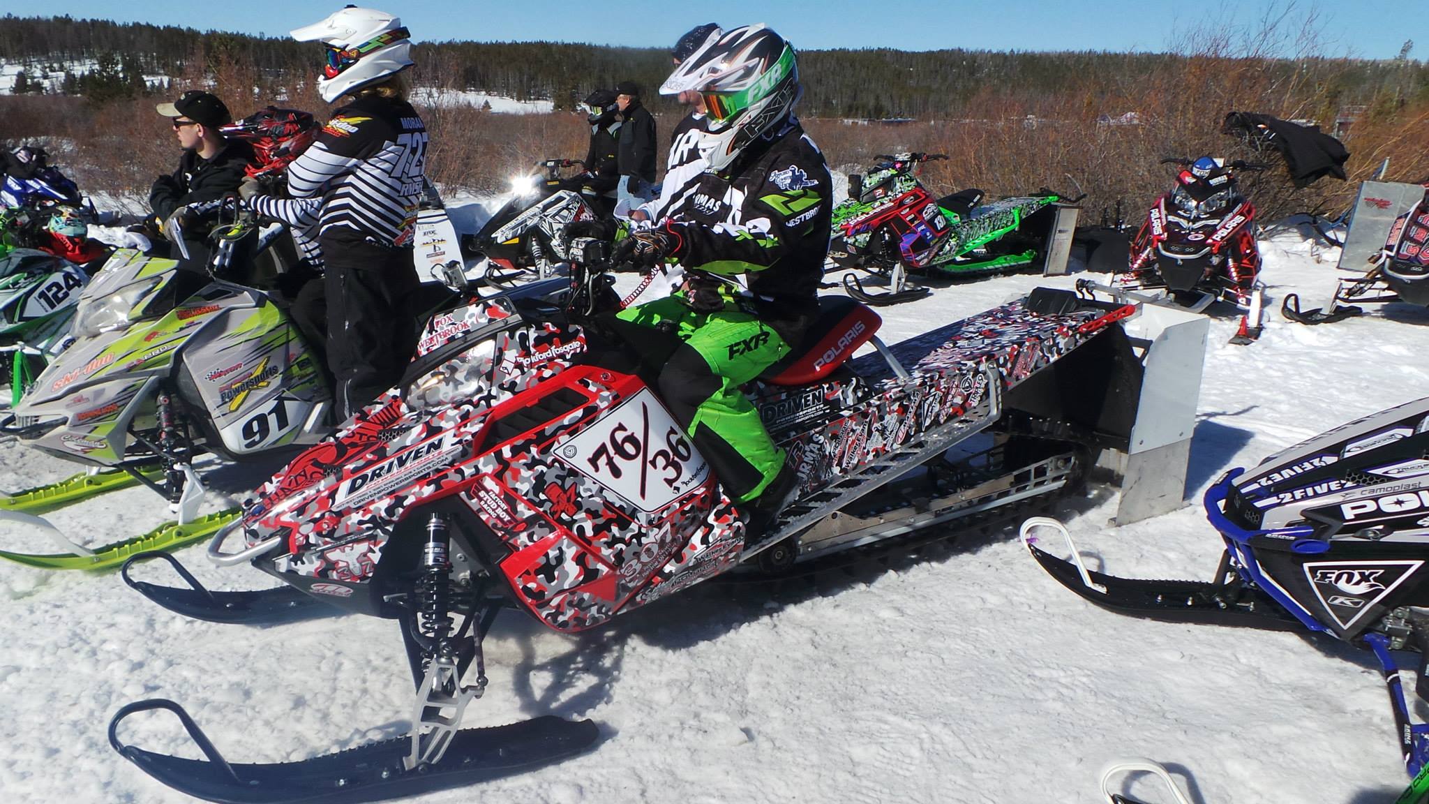 A Polaris Pro-Ride snowmobile with a red, black, and white Snow Camo custom vinyl wrap.