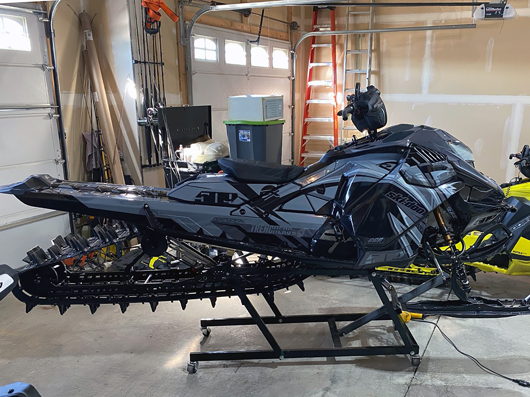 A Ski-Doo Gen4 Lightweight snowmobile with a gray and black Kesterke Adrenaline custom vinyl wrap.